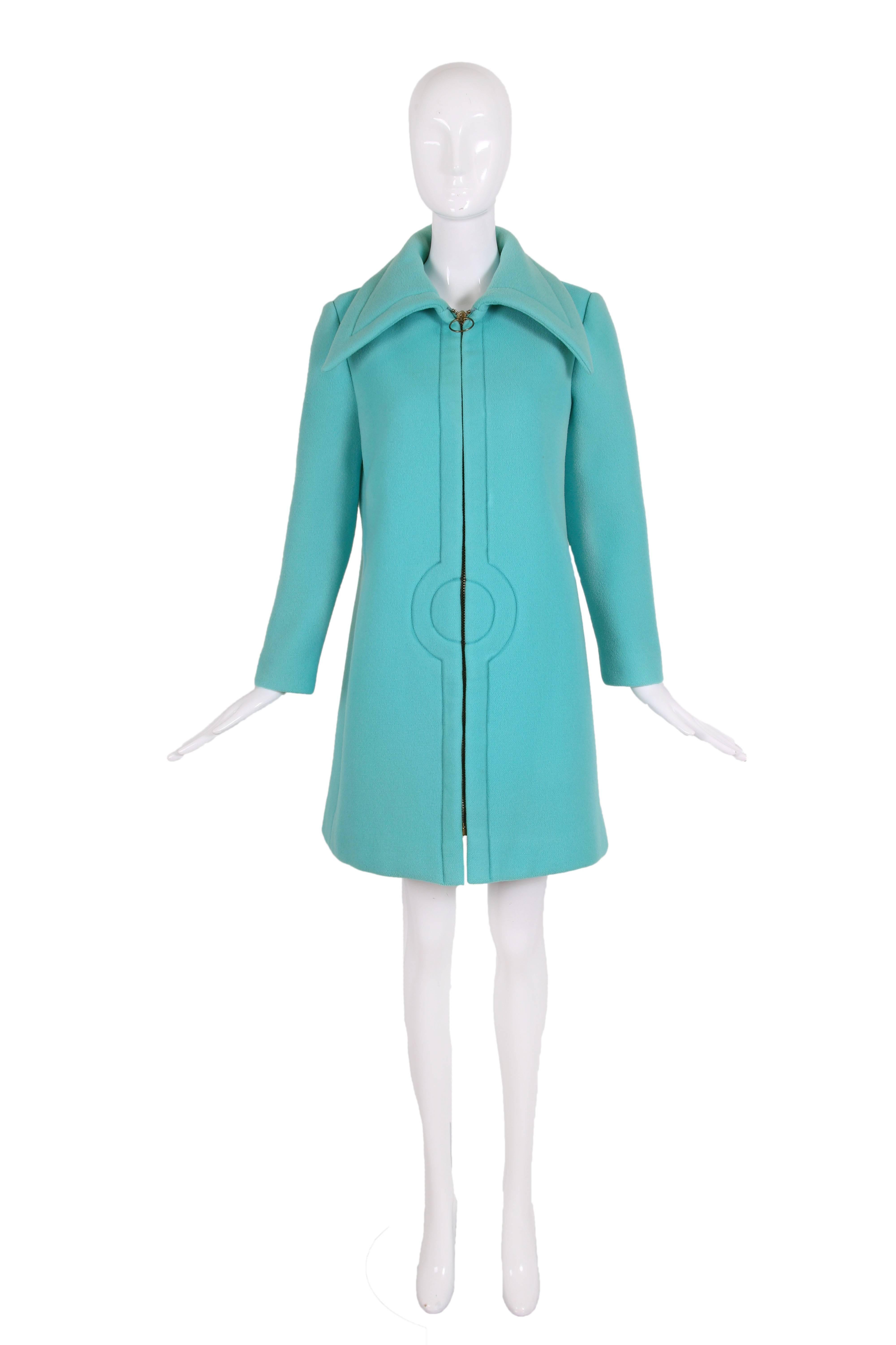 Late 1960's/early 1970's Pierre Cardin aqua blue melton wool coat with oversized collar and classic Cardin stitched circle design motif at center front near waist. Oversized metal zipper closure at center front with oversized circular metal zipper