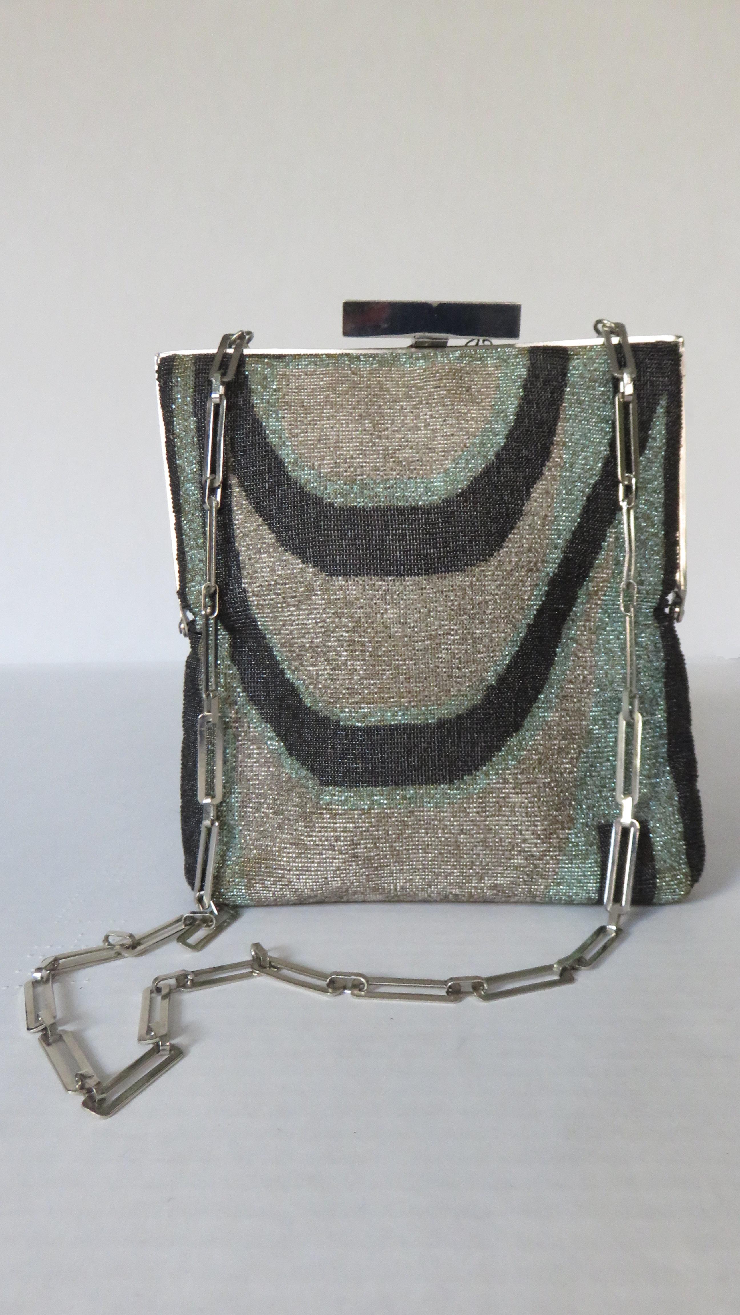 A fabulous Pierre Cardin shoulder bag in black, silver and mint green micro beading.  It has a silver rectangular link chain strap, frame, and rectangular PC engraved top clasp closure.  Each side has a unique abstract pattern.  It is lined in off