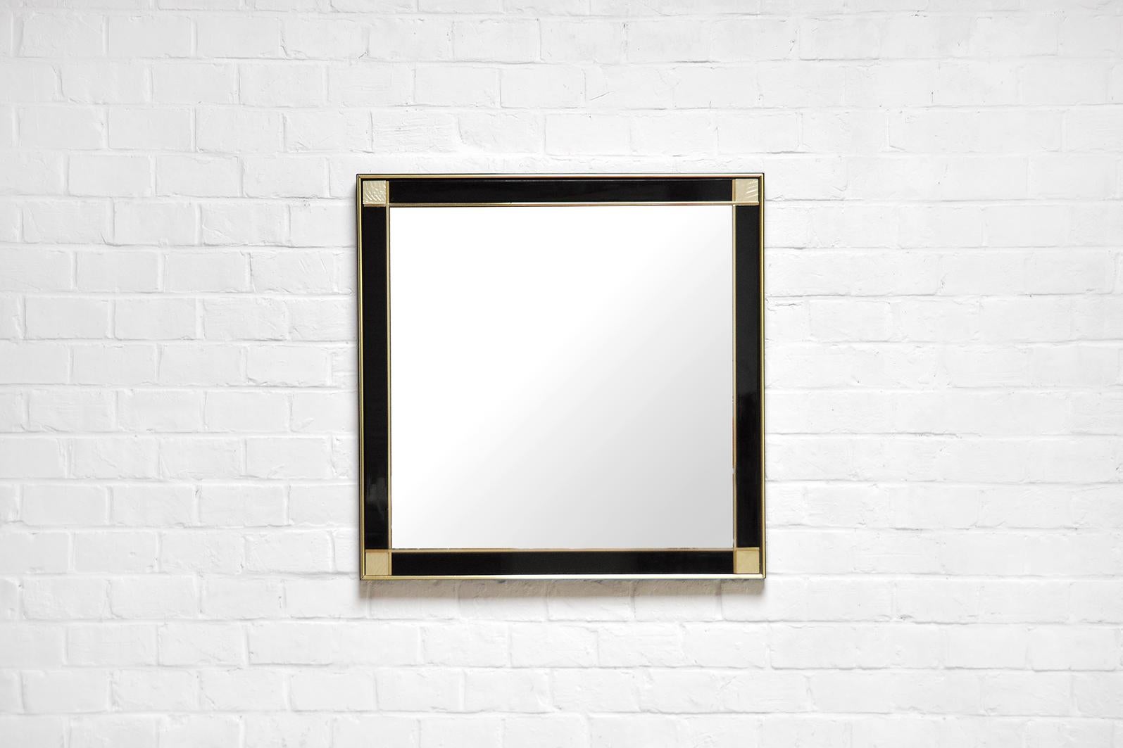Vintage mirror designed by French designer Pierre Cardin in the 1980s. This large mirror is constructed out of black lacquered wood and finished with beautiful brass & stone details. In great condition.
    