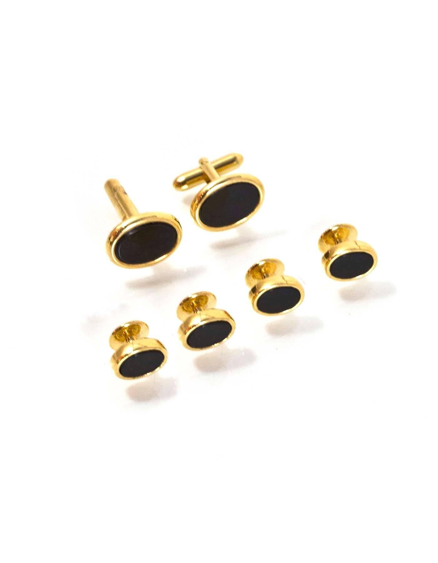 Pierre Cardin Black Onyx & Goldtone Tuxedo Set
Features two cufflinks and four buttons

Color: Black, gold
Hardware: Goldtone
Materials: Onyx, metal
Overall Condition: Excellent good pre-owned condition, light surface marks and tarnish
Inlcuded: