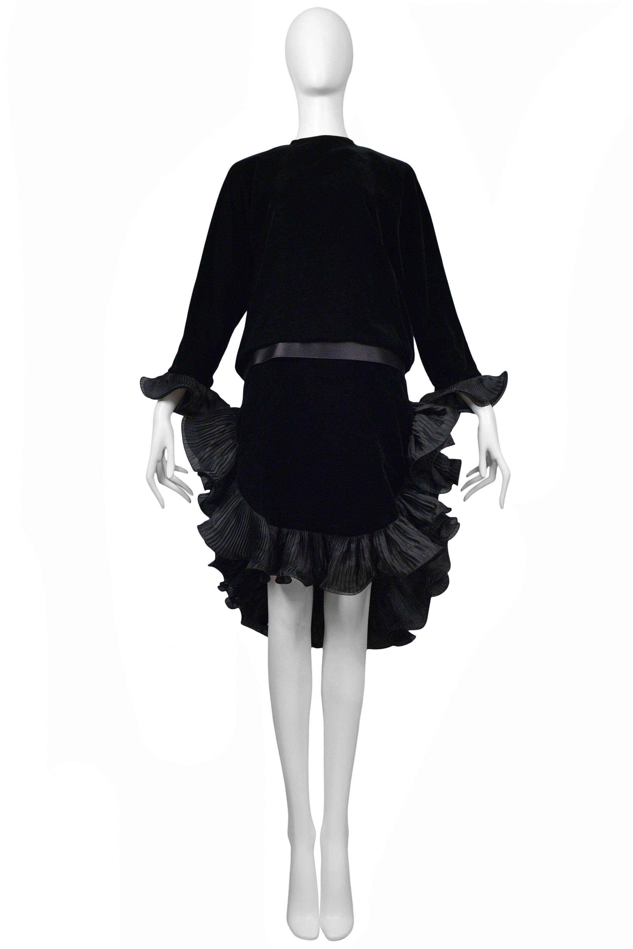 Resurrection Vintage is excited to offer this vintage Pierre Cardin black velvet cocktail dress that features taffeta ruffles, long sleeves, ribbon waistband, and high low length. 

Pierre Cardin, Paris
Size: Small or today's 2
Velvet, Satin