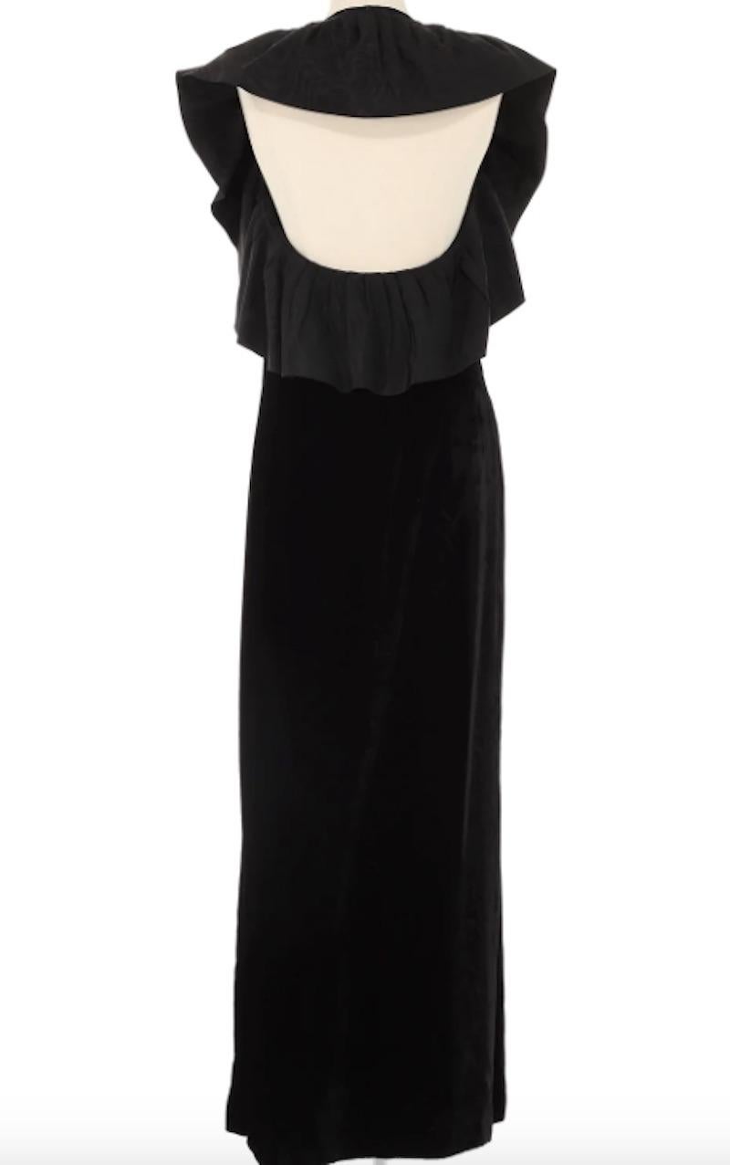 Truly a unique dress by the ever so talented Pierre Cardin. Dating back to the 1960s, this piece is thoughtfully designed with a beautiful black velvet bodice accompanied by a black ruffle creating an illusion of sleeves. The open back allows for a