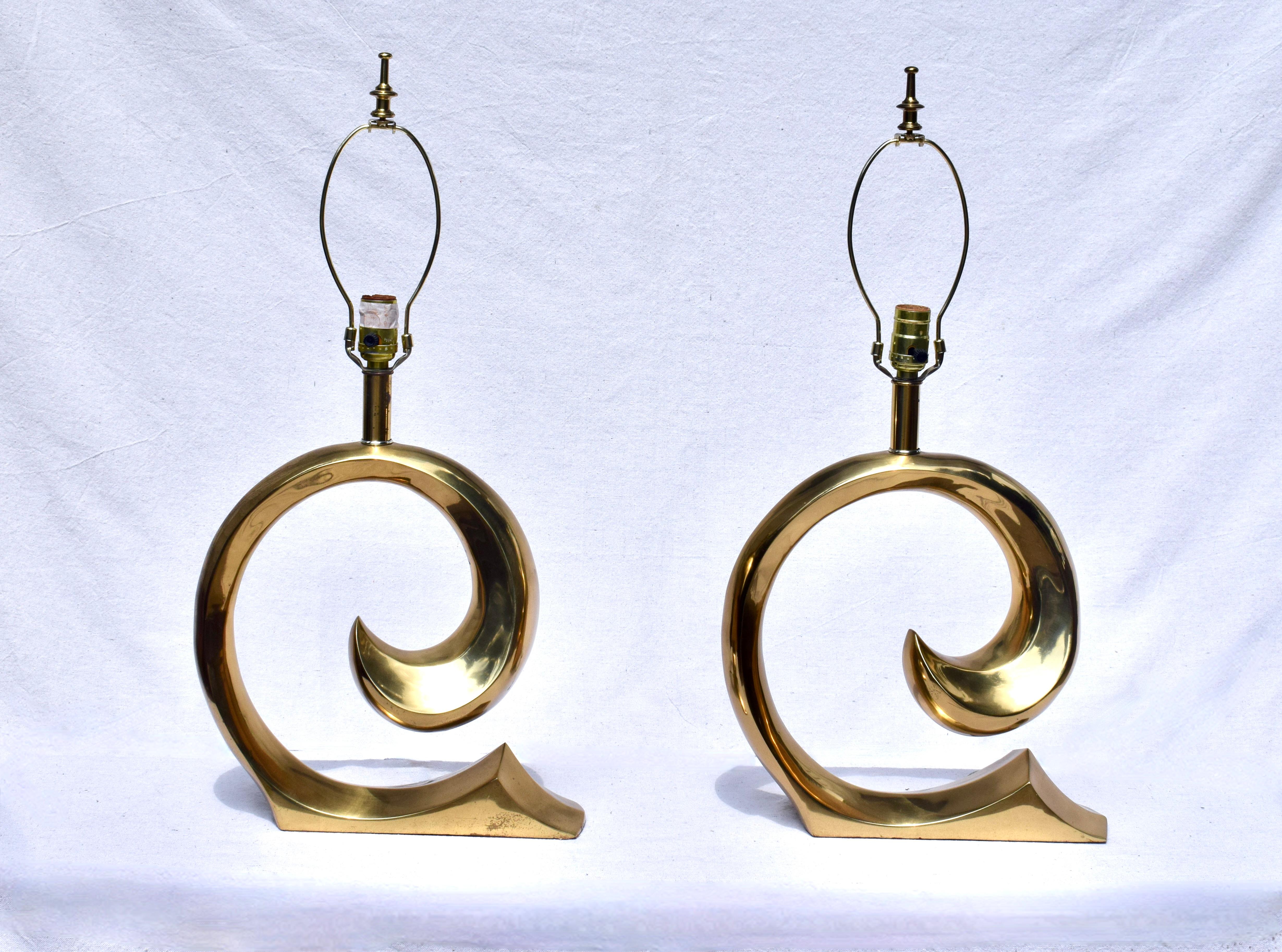 A pair of 1970's Pierre Cardin Brass Modernist lamps with original finials & three way lighting option. Exquisite matching tortoise lined parchment shades are included.