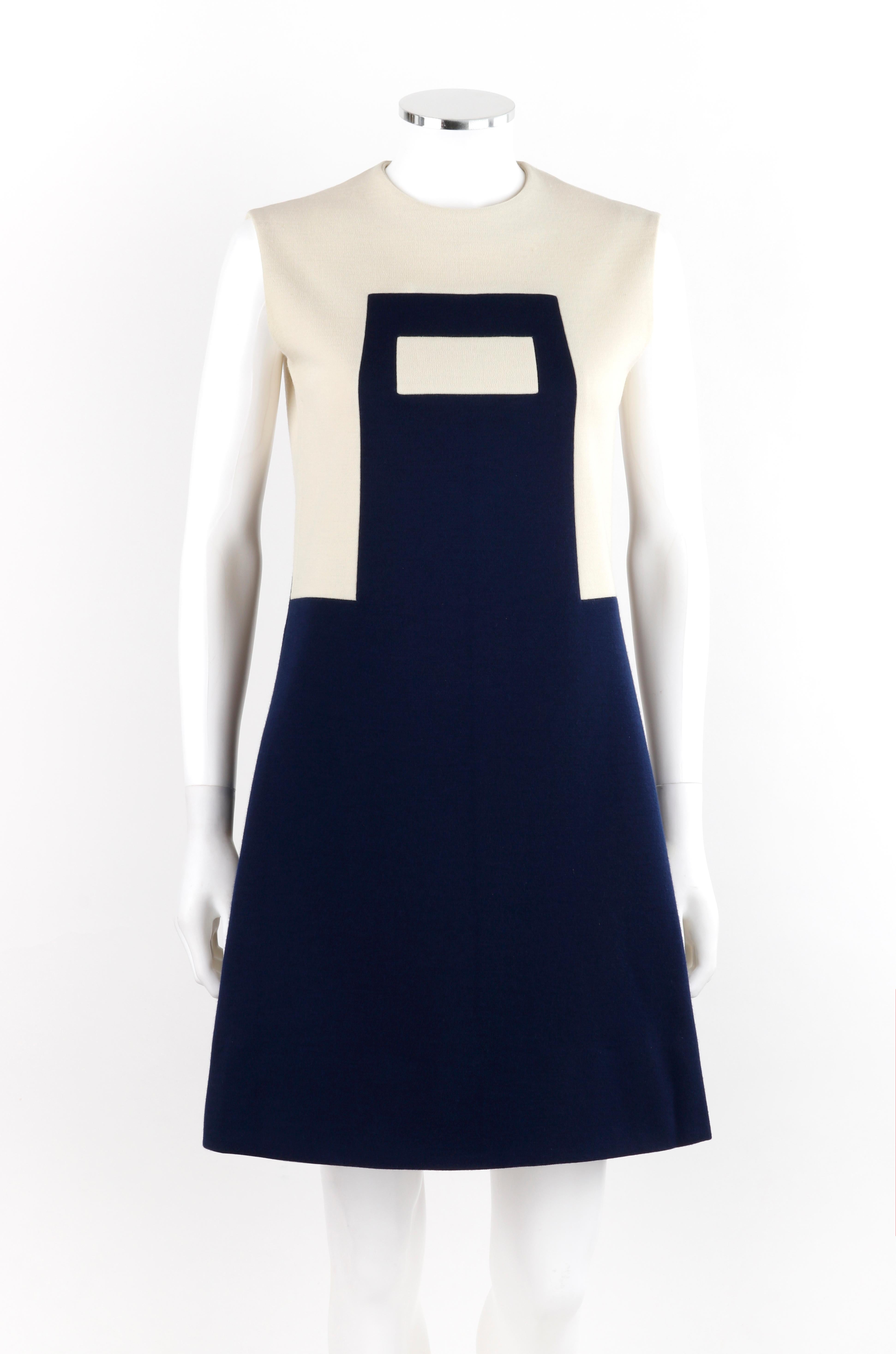 PIERRE CARDIN c.1960’s Navy Cream Geometric Mod Color Block Mini Dress
 
Circa: 1960’s
Label(s): Les Jerseys de Pierre Cardin
Designer: Pierre Cardin
Style: Sleeveless a-line mini dress
Color(s): Shades of navy blue and off white
Lined: Yes
Marked