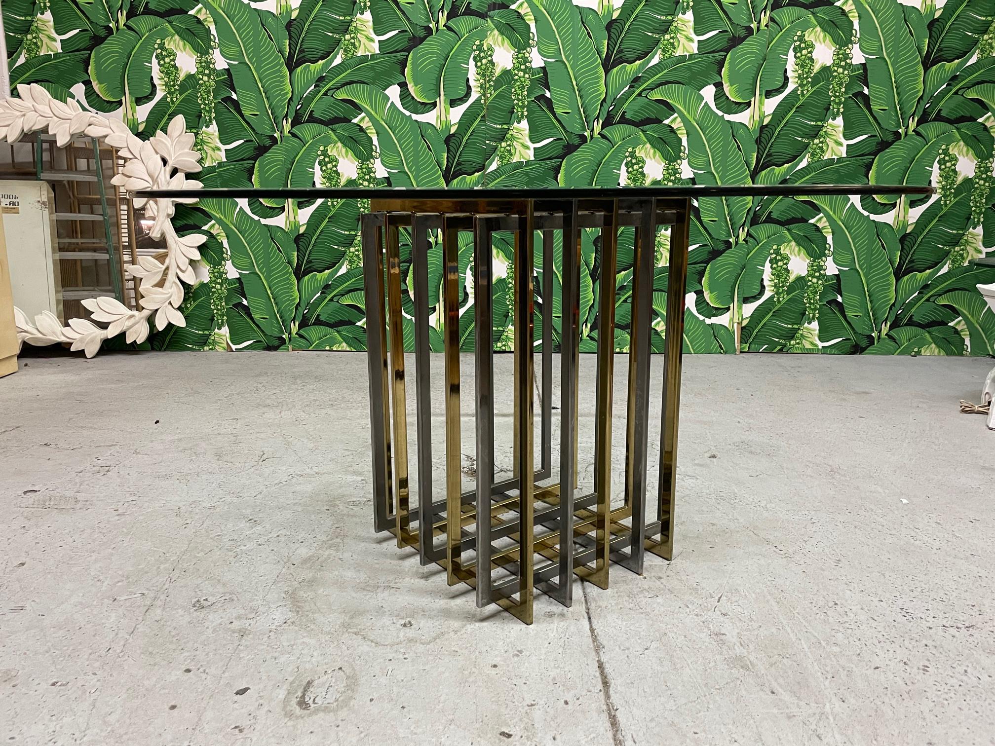 Pierre Cardin mixed metal cubist dining table. Alternating bands of brass and chrome form a square, or can be adjusted to become a diamond shape. Very heavy. Includes a 54