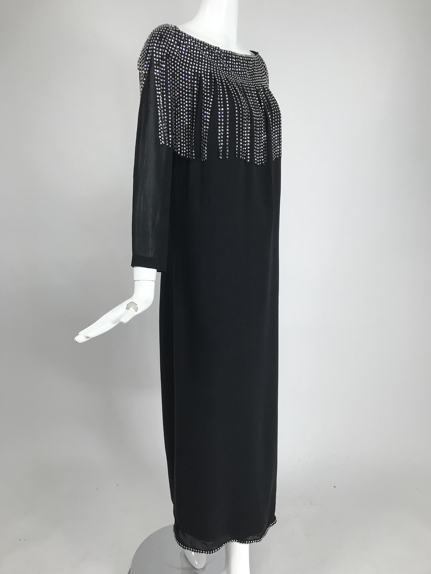 Pierre Cardin Couture black slub silk gown with rhinestone car wash bib, from the 1960s. A simple and elegant long sleeve column gown that tapers from the wide neckline to a narrow hem that has a double row of rhinestones. The dress is hand made.