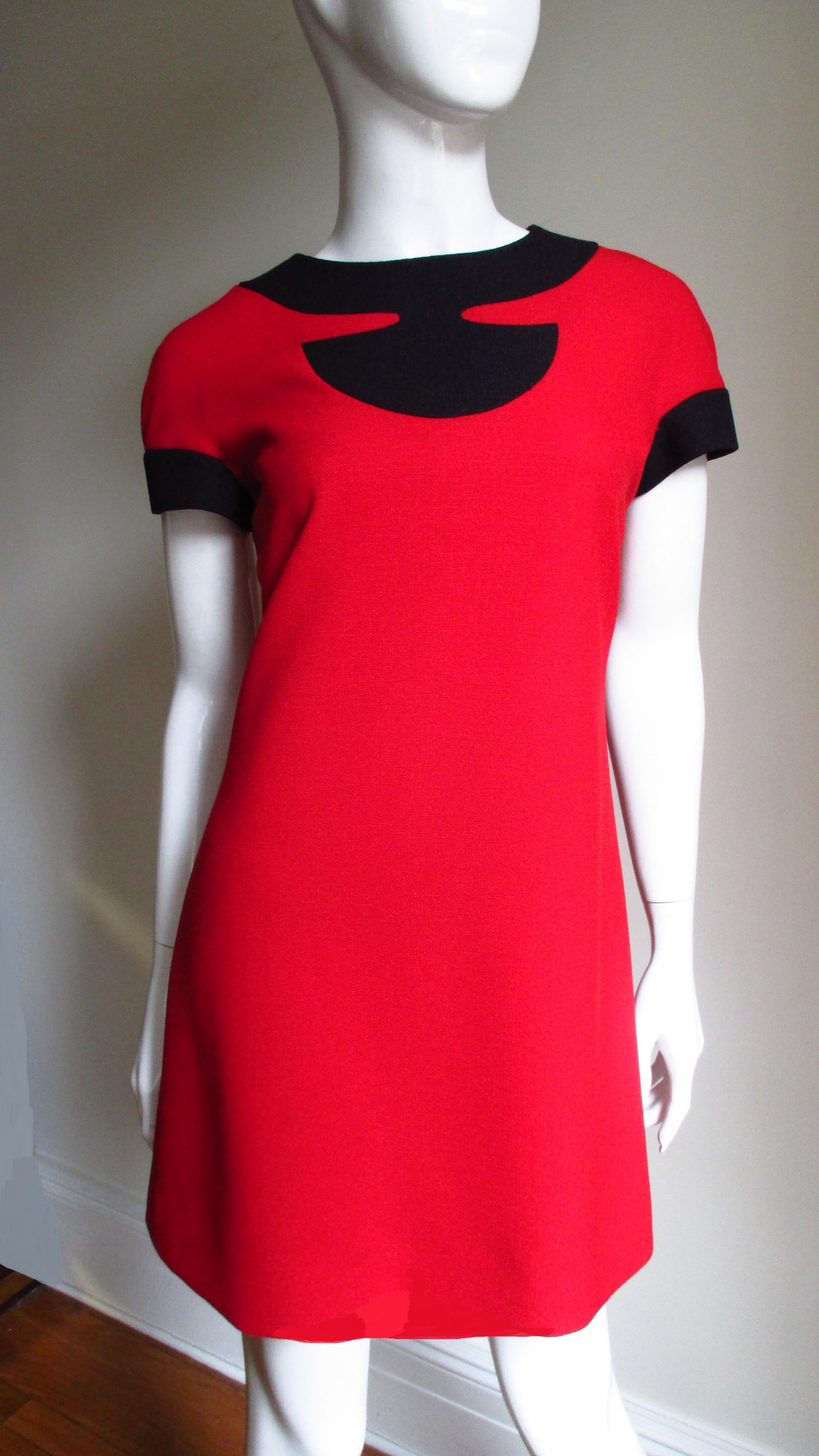 A fabulous much documented in the 1960s red and black dress from the master Pierre Cardin.  It has a crew neckline and short sleeves both with black trim.  It is fully lined in red and has a back zipper.
Fits sizes Small, Medium.

Bust 38