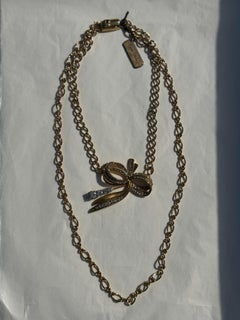 Pierre Cardin double-strand choker necklace, gold chain and rhinestone bow