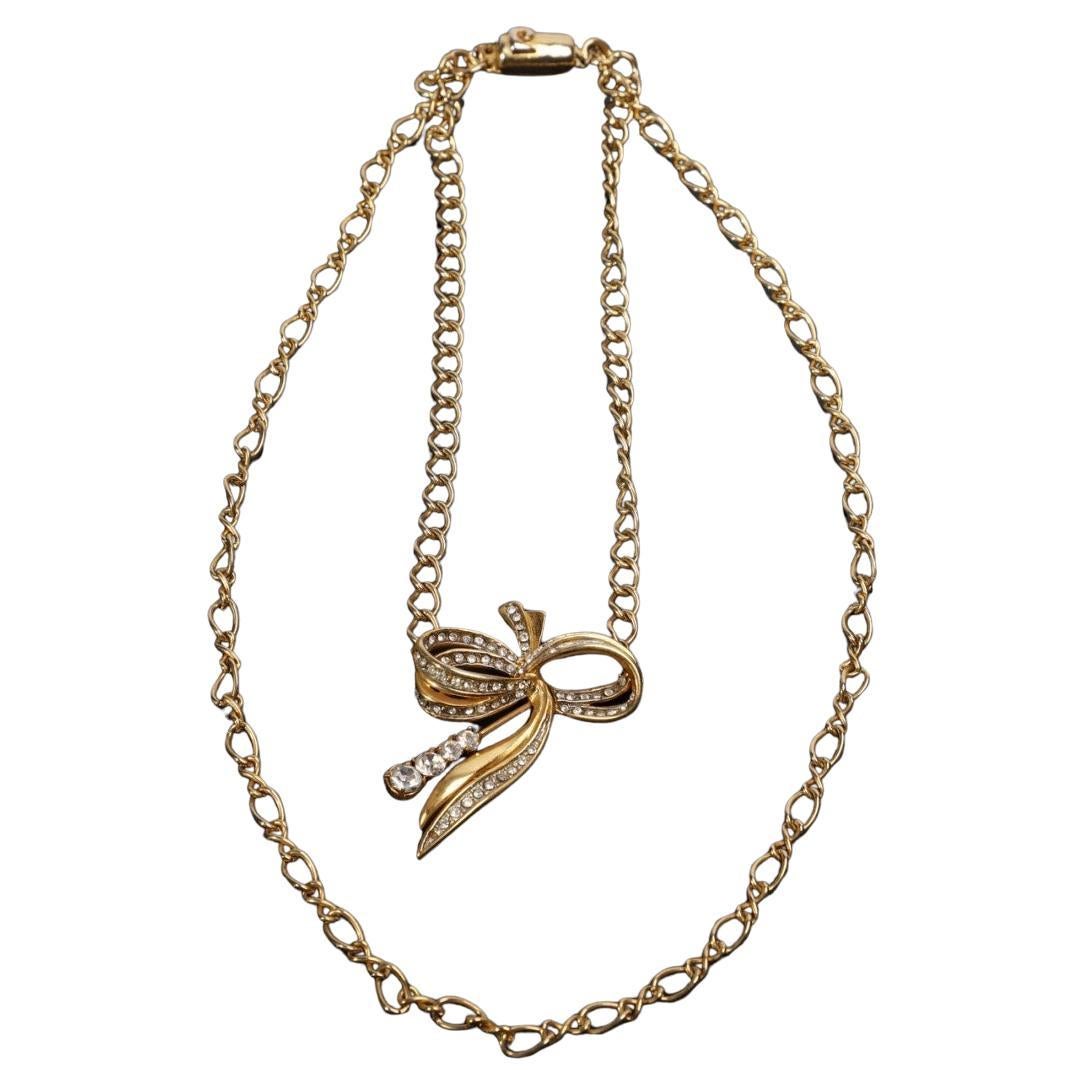 Pierre Cardin double-strand choker necklace, gold chain and rhinestone bow