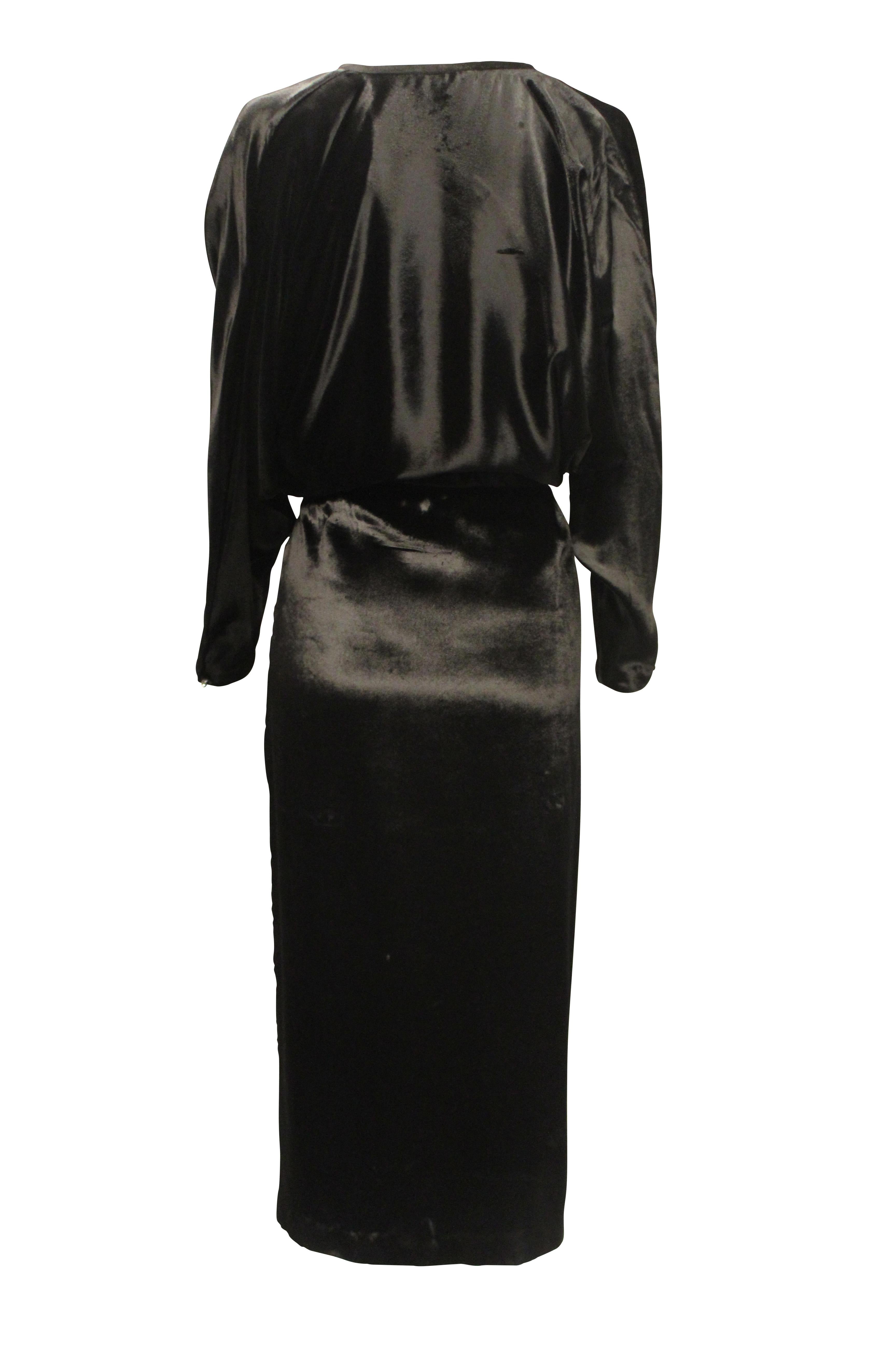 Vintage Pierre Cardin fully lined slinky velvet dress with bat wing sleeves, deep V neckline and 3 tie up velvet strands that can be left undone or tied across the neck line. 