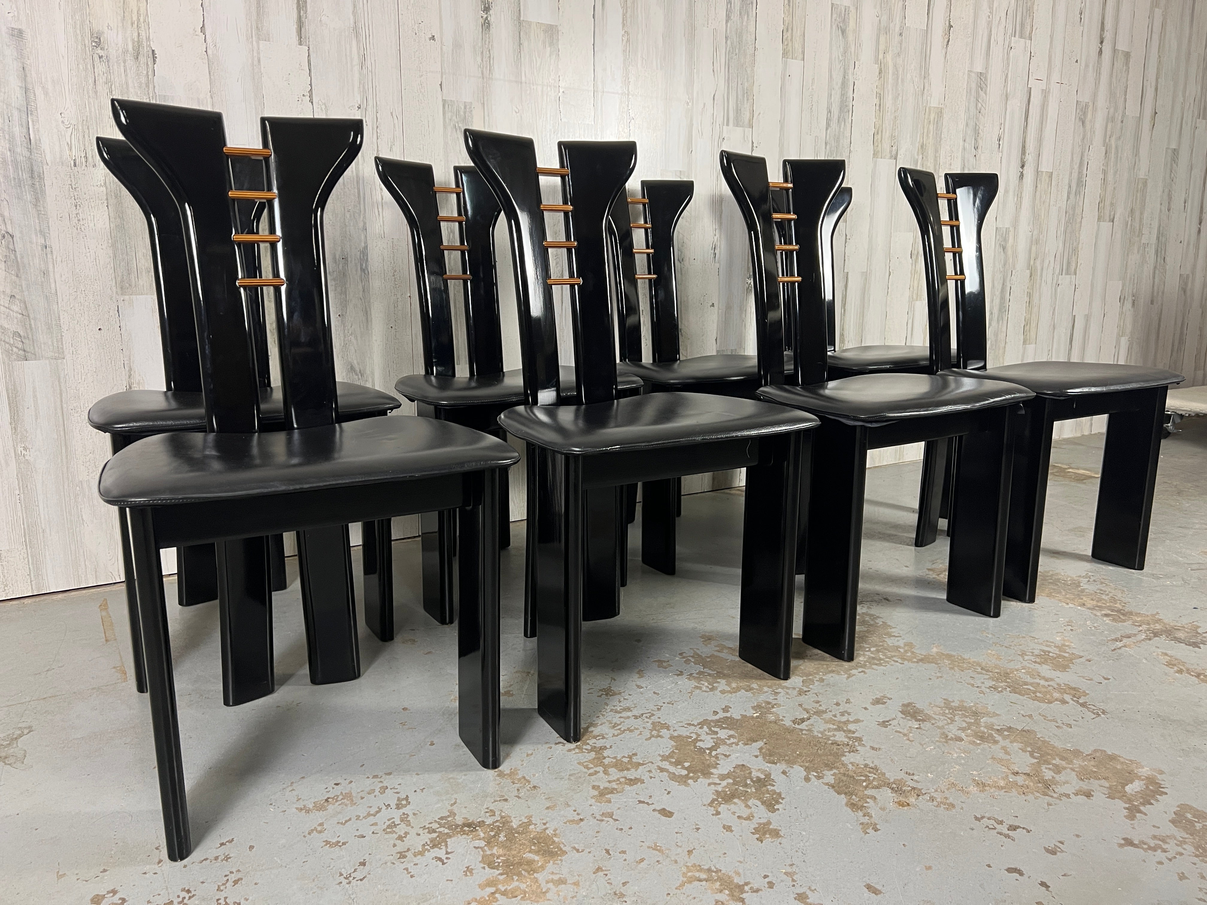 Pierre Cardin For Roche Bobois Italian Black Lacquer dining chairs- Set of 8. Black lacquer finish with wood accents. Sculptural split back with a multi-layered wood detail. Supple European blackleather 