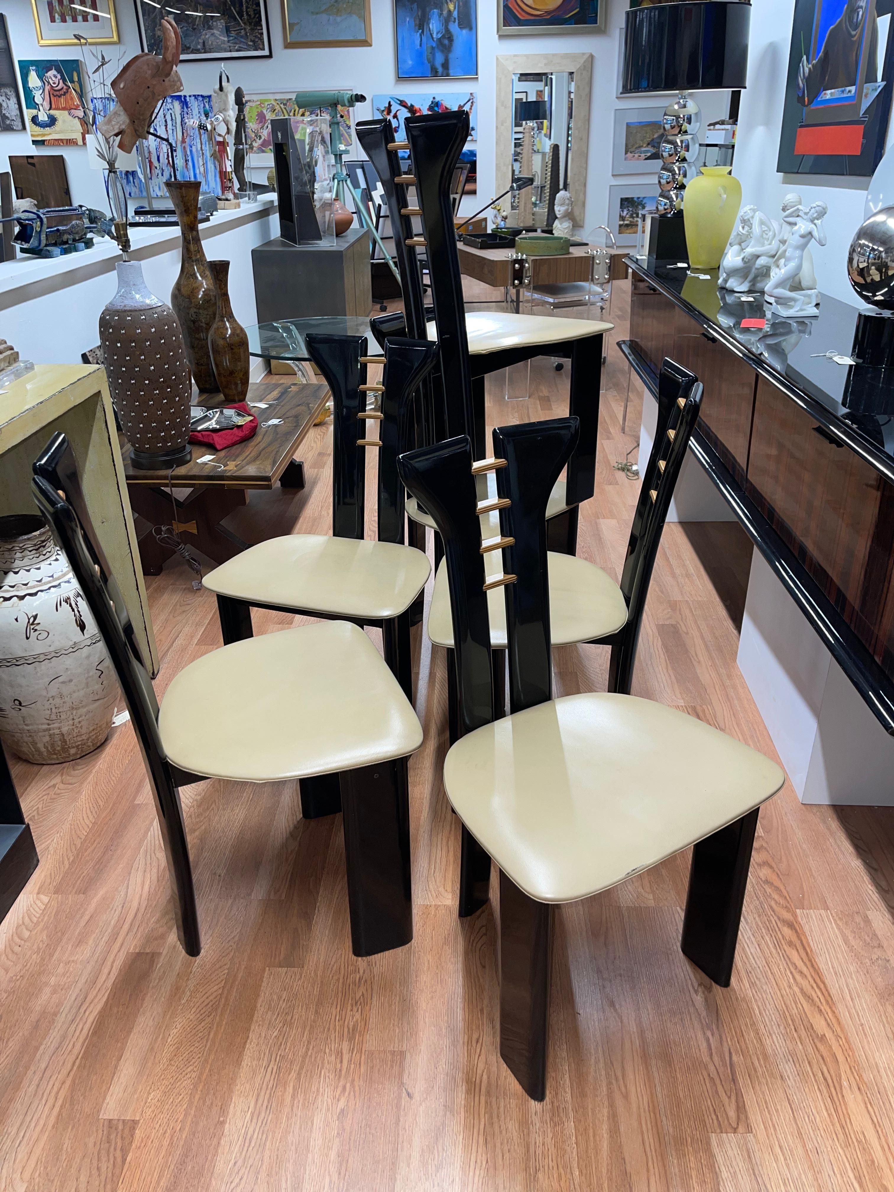Beautiful elegant set of 6 1970’s Pierre Cardin designed dining chairs by Roche Bobois. Original beige leather seats. Black lacquer finish with wood accents. Good overall age appropriate condition with some marks to the lacquer and leather cushions.