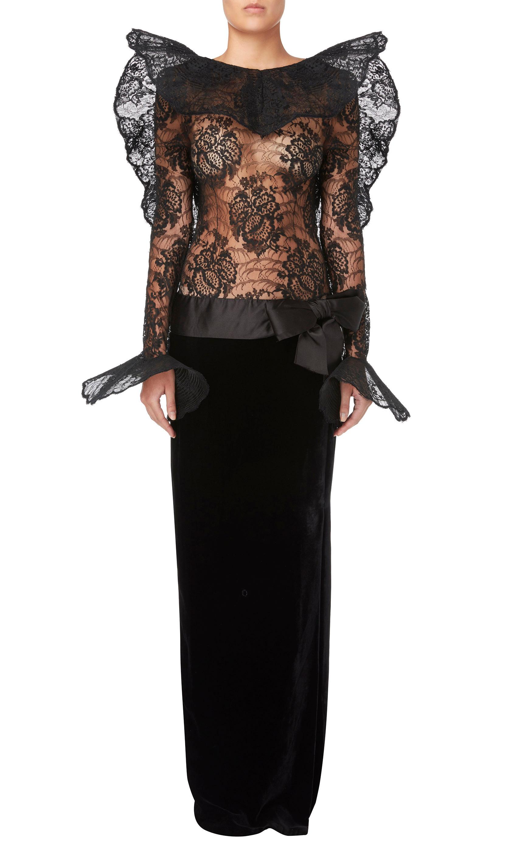 An incredible piece of Pierre Cardin haute couture, this gown will make a show-stopping choice for a red carpet event. The form fitting black lace bodice is completely sheer with a high neck to the front and plunging back, while the oversized ruffle