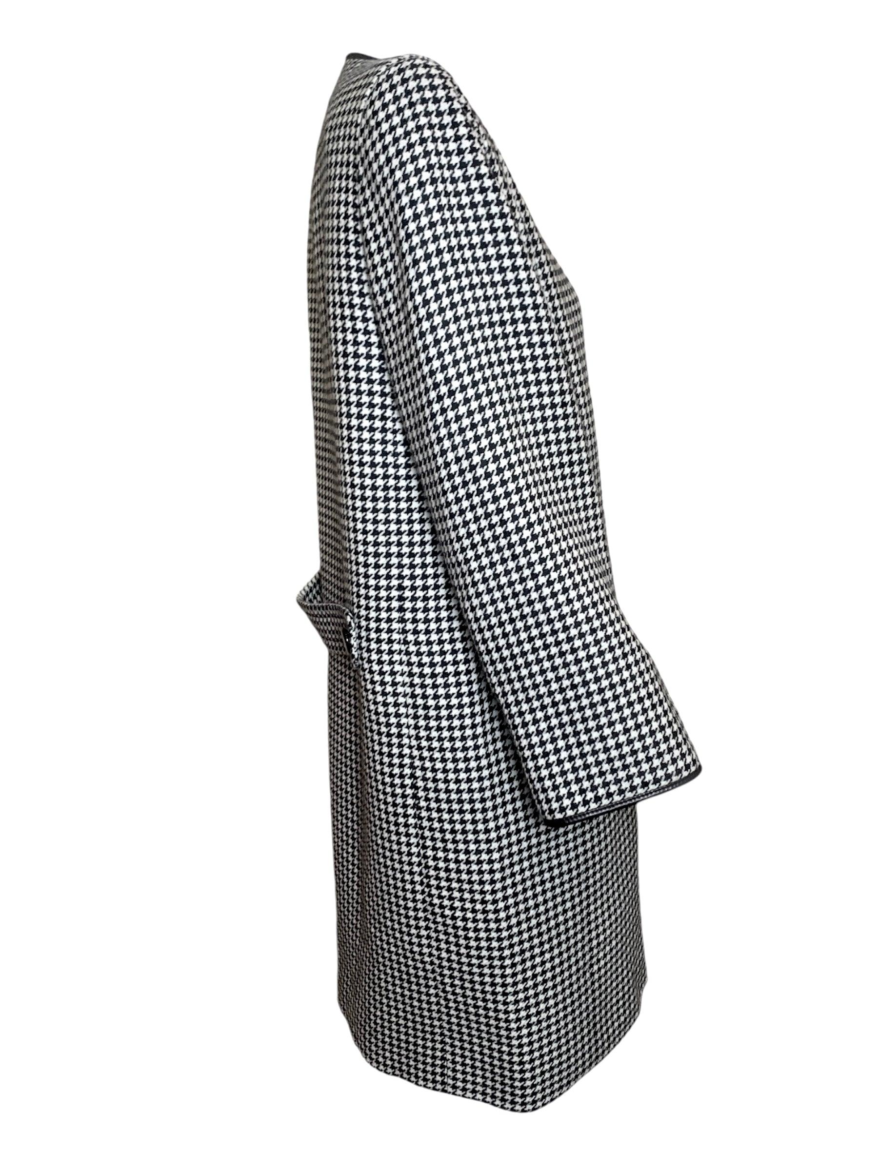 Timeless and elegant with a hint of mod detailing, this classic haute couture coat has just the right touch of individuality. Cardin's tinge of nostalgia for the 60s blends beautiful with this very 80s silhouette. The shoulder pads are well