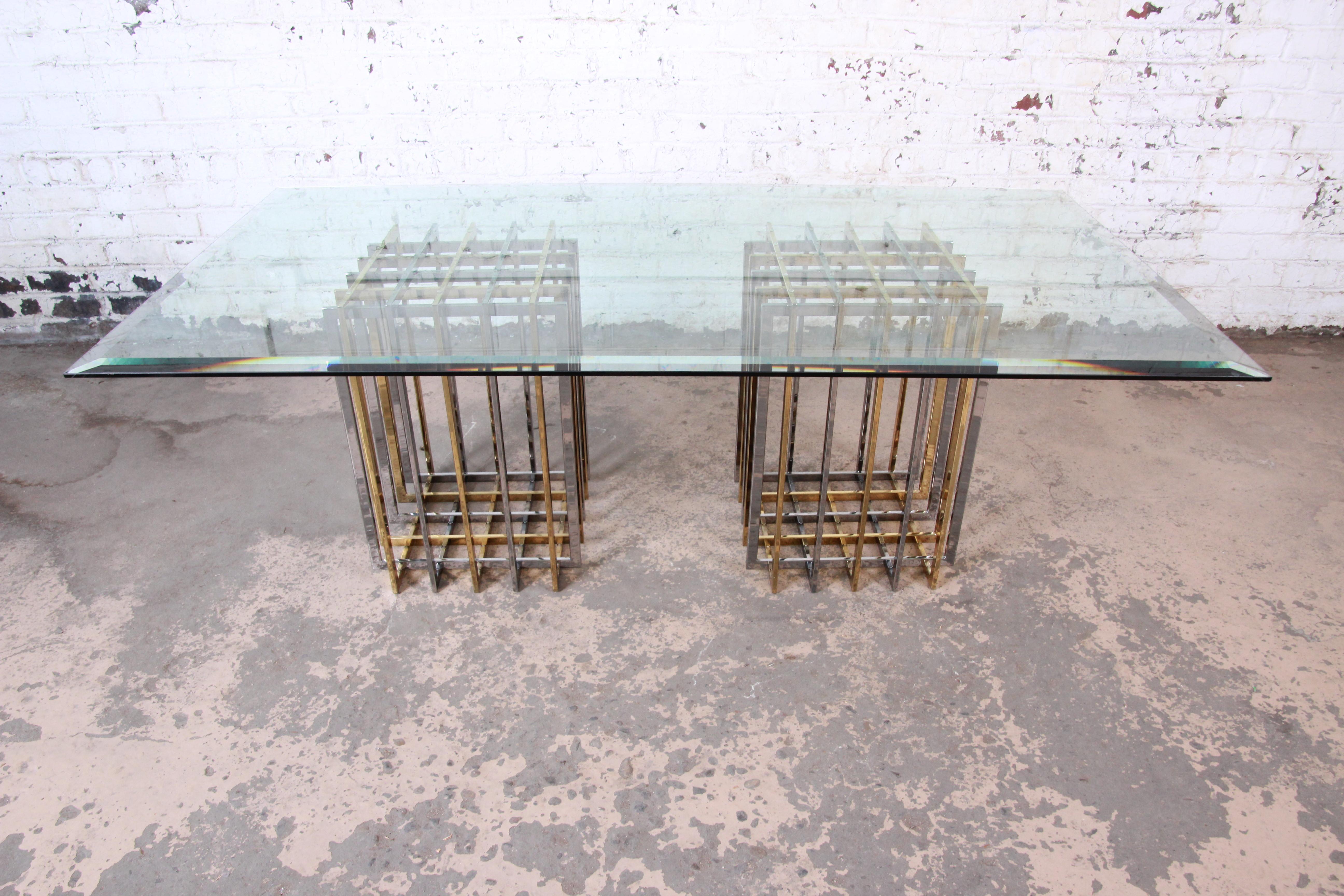 A rare and exceptional Mid-Century Modern double pedestal Hollywood Regency dining table

By Pierre Cardin

USA, circa 1970s

Bases comprised of alternating flat bar squares in nickel and brass. Tabletop is a thick beveled glass.

Measures: