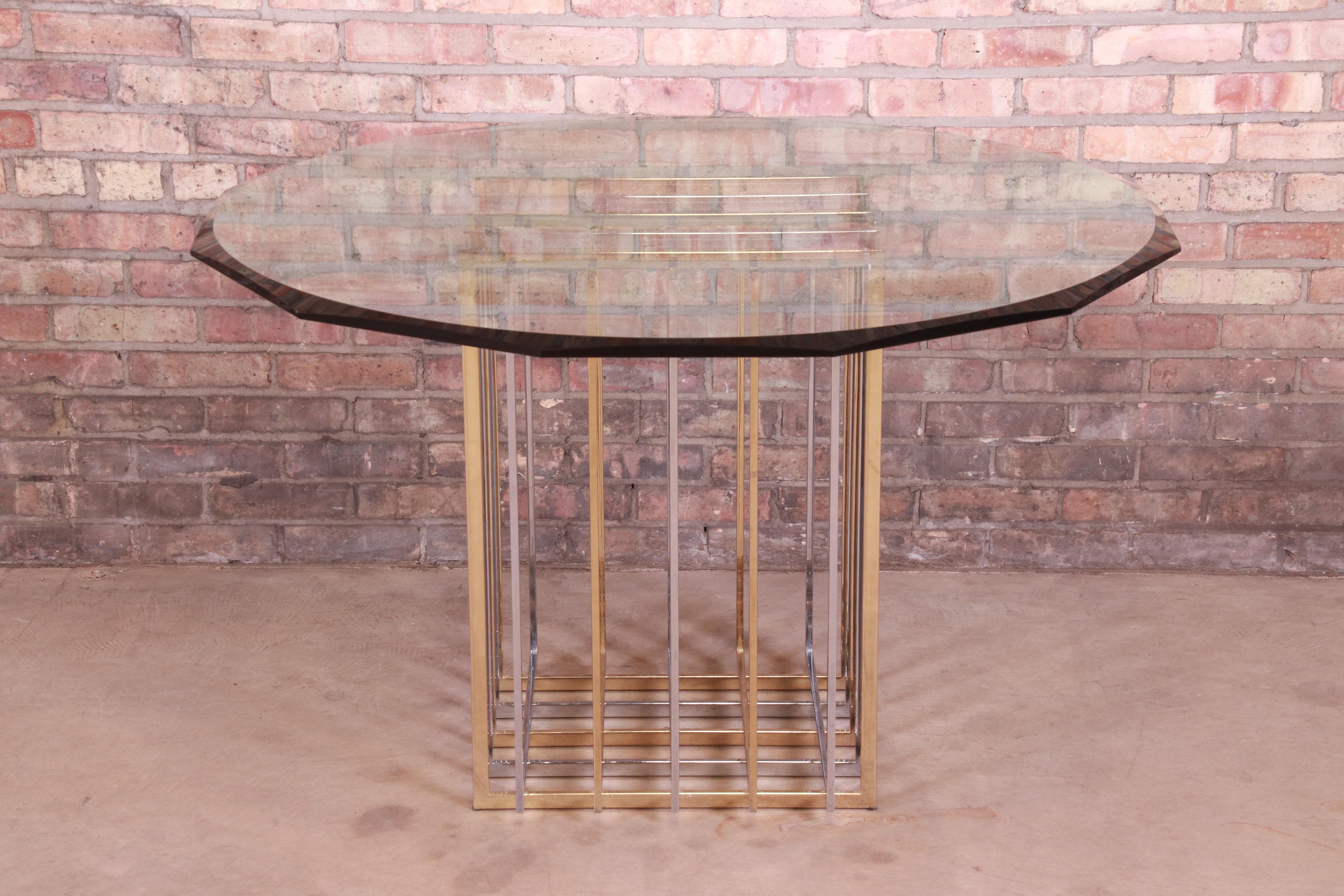 A rare and exceptional Mid-Century Modern Hollywood Regency pedestal dining or game table

By Pierre Cardin

USA, circa 1970s

Base comprised of alternating flat bar squares in nickel and brass. tabletop is a thick beveled glass.

Measures:
