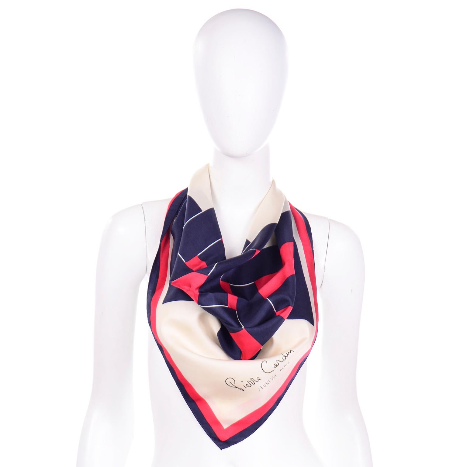 This is a beautiful vintage Pierre Cardin silk scarf in a color block style print in shades of  navy blue, red, and ivory throughout. The hem of this scarf is hand rolled and it is 100% Silk. 

30