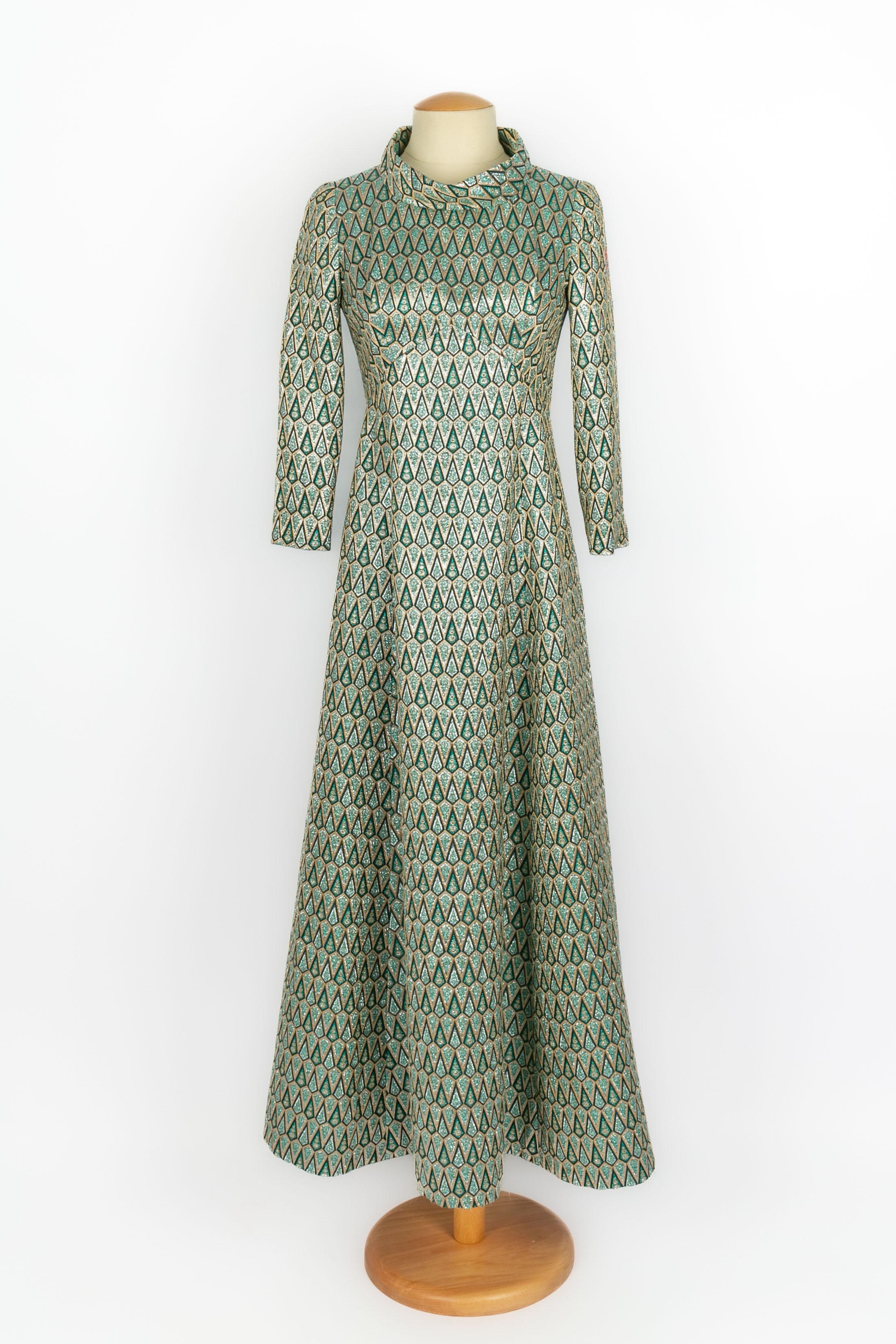 PIERRE CARDIN - (Made in France) Langes grünes und goldfarbenes Lurexkleid mit langen Ärmeln. Größe und Zusammensetzung Etiketten fehlen, es passt ein 36FR. Ein Stück aus den 1960er Jahren. Zu erwähnen sind einige rote Reflektionen auf der Oberseite