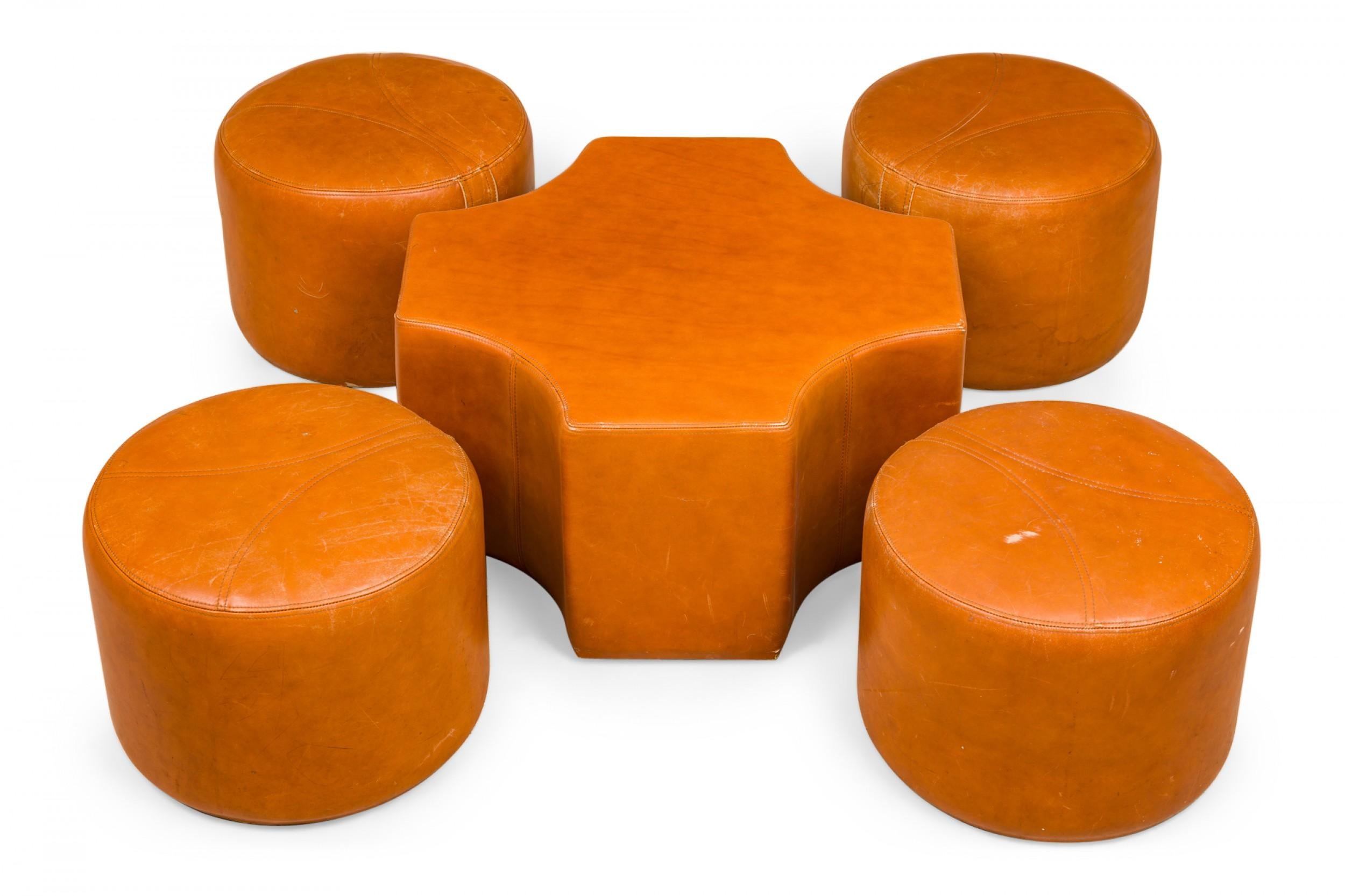 Mid-Century Modern caramel leather coffee / cocktail table base with scooped sides and four nested cylindrical stools in matching upholstery. (Priced as set)(Pierre Cardin).
    