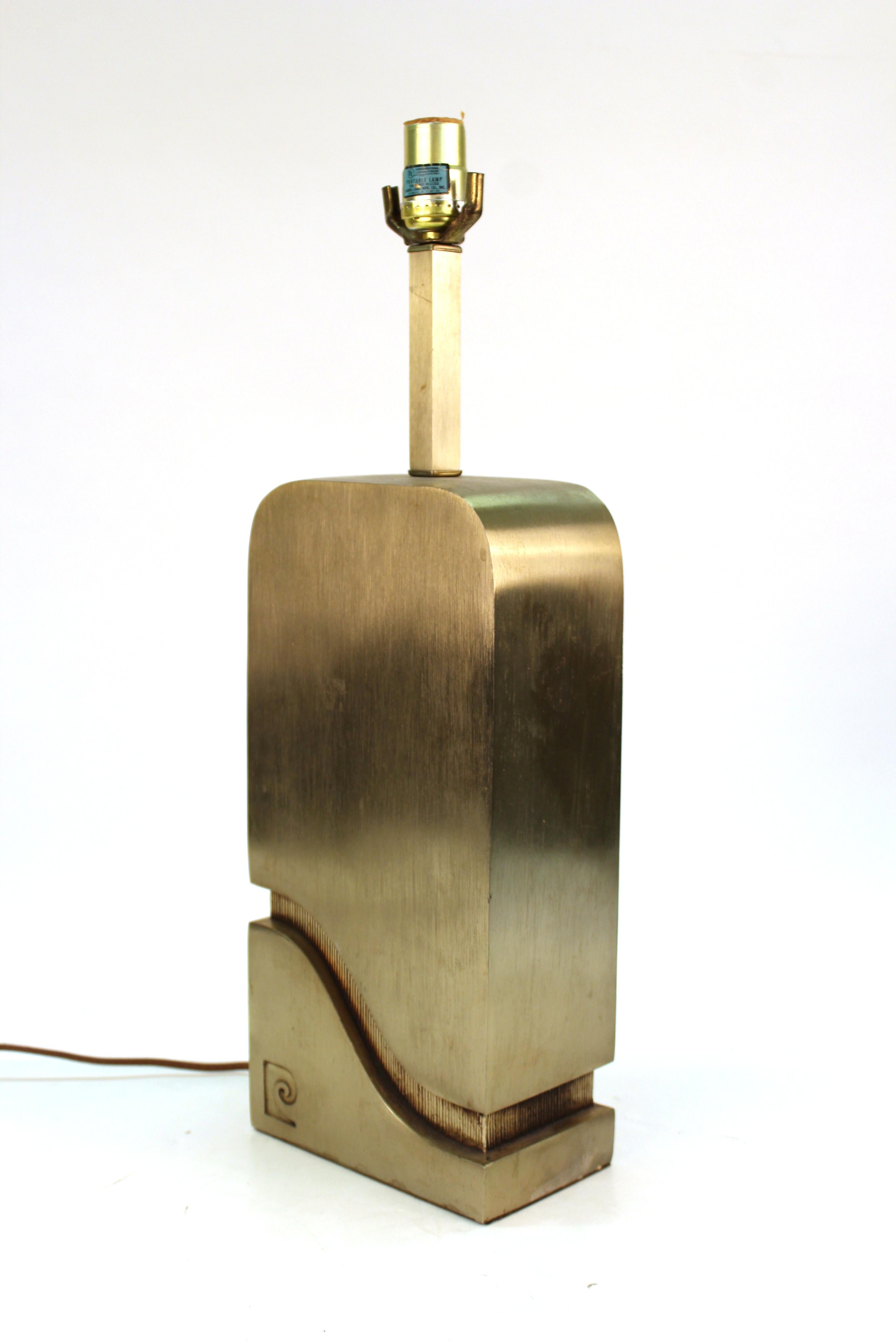 Modern metal table lamp with heavy rectangular body, created by Pierre Cardin in the 1970s. The piece has the Pierre Cardin monogram on the front side and is in great vintage condition, with some age-appropriate patina and wear.
