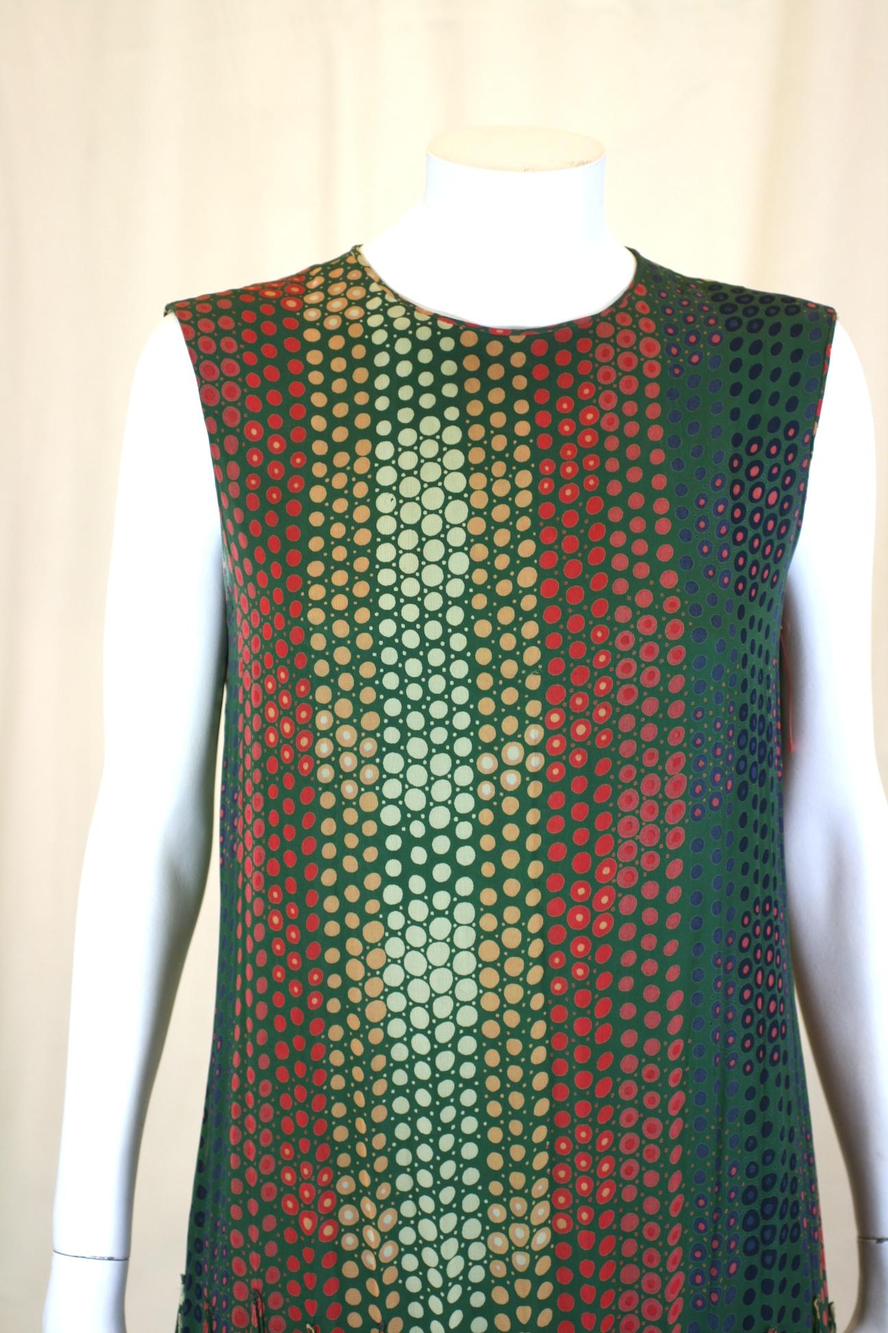 Unusual Pierre Cardin Op Art Scarf Hem Dress in hyponotic rayon georgette print. A simple sleeveless sheath has dozens of scarves applied at hip level to create a super interesting silhouette with movement. Very possibly designed by Jean Paul