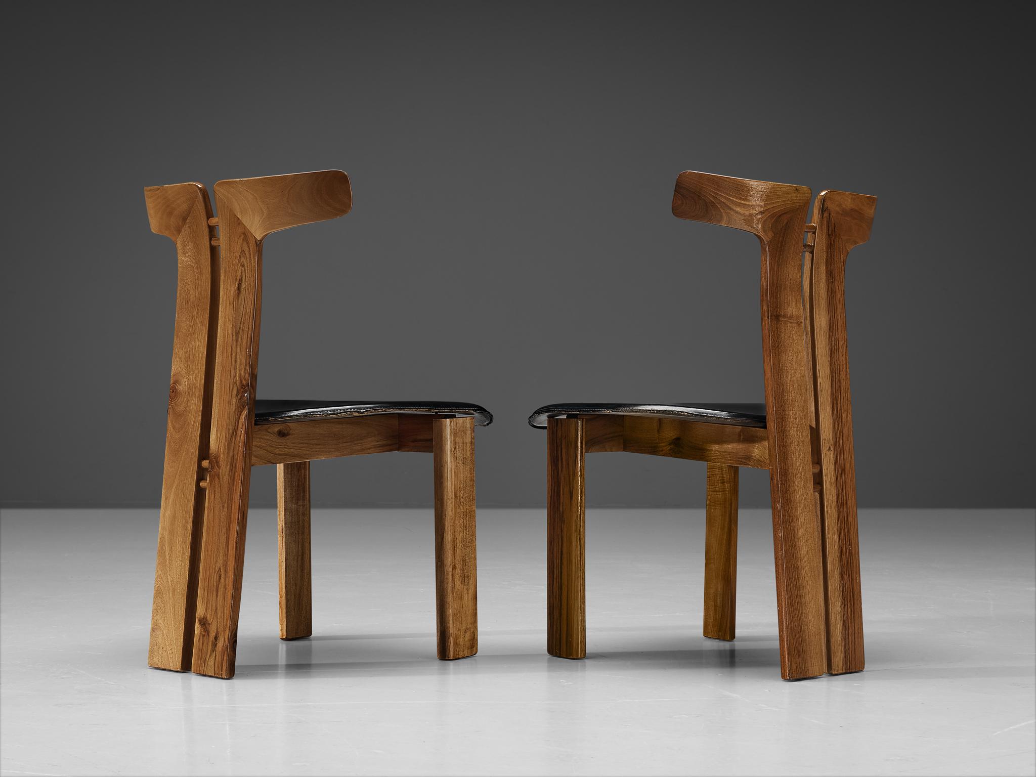 Pierre Cardin, pair of dining chairs, walnut, leather, Italy, circa 1980. 

This sculptural chair is designed by Italian designer Pierre Cardin (1922-2020). The curved back highlights the qualities of the wood and its shape in an unparalleled