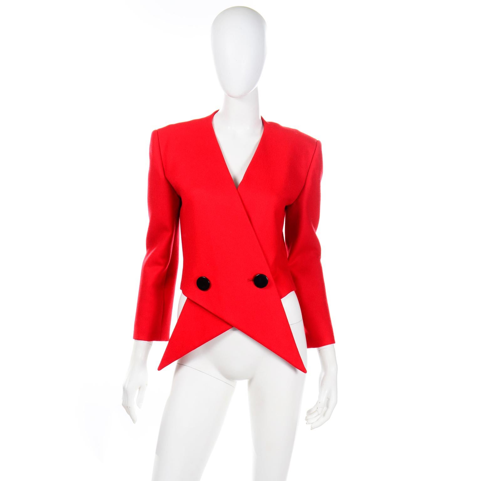 This is such an incredible,  unique avant garde jacket created by Pierre Cardin. This fabulous wool jacket is double breasted with two large black buttons in front that attach to the dramatic criss-crossing pointed front hem pieces. This creates a