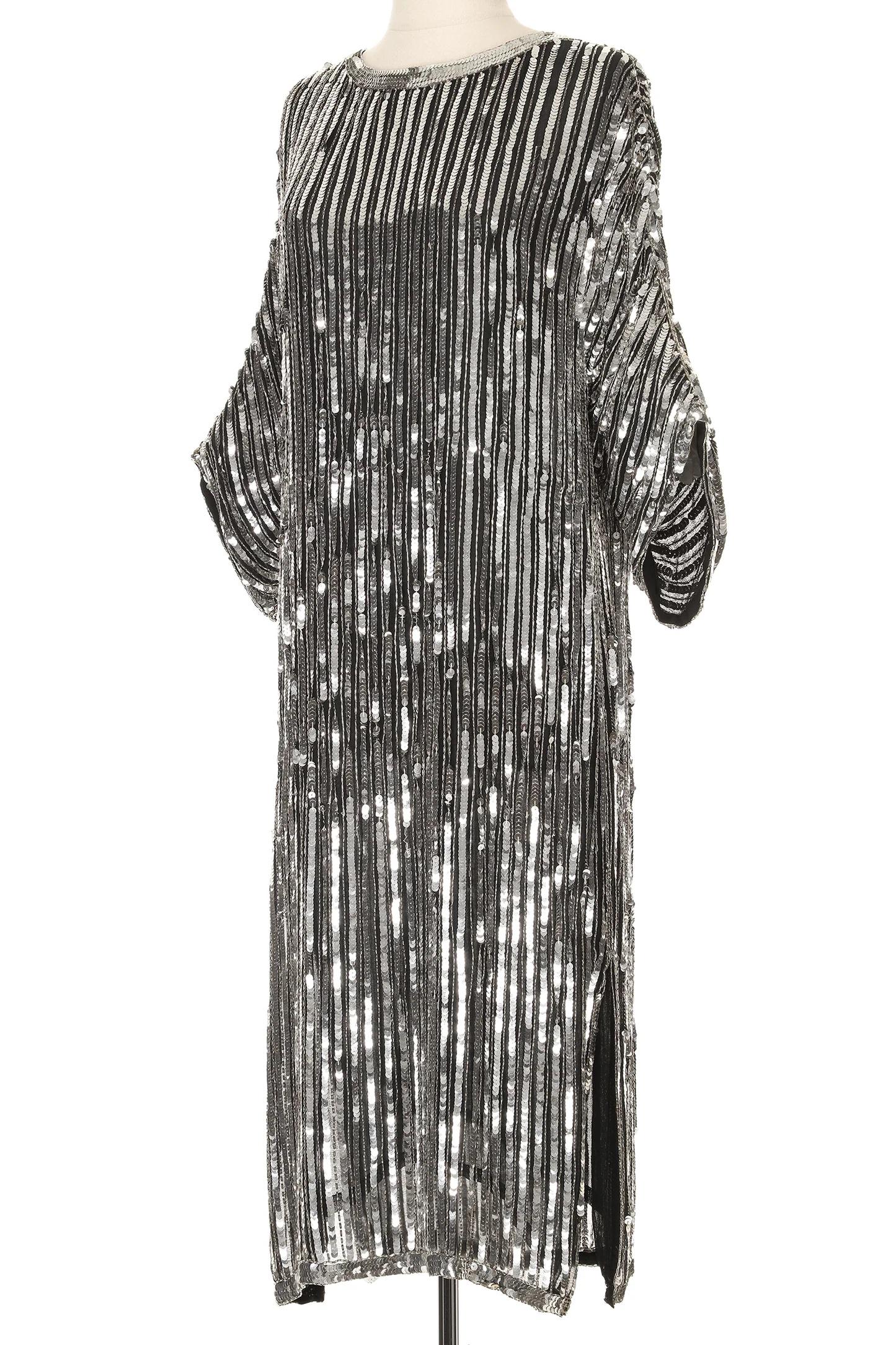 VINTAGE GRACE NY

This dazzling Pierre Cardin dress radiates 1960s glamour with a modern twist. Crafted in shimmering silver and black sequins, it features bold vertical stripes that elongate the silhouette, while the loose, boxy cut offers both