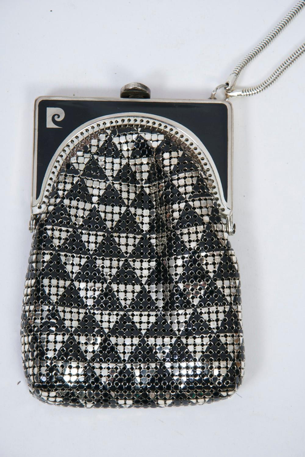 Pierre Cardin Art Deco-style evening pouch of silver and black metallic mesh arrayed in a diamond pattern. The black enameled silver metal frame sports the designer's logo in silver on the left. On the right side of the frame is a silver snake chain