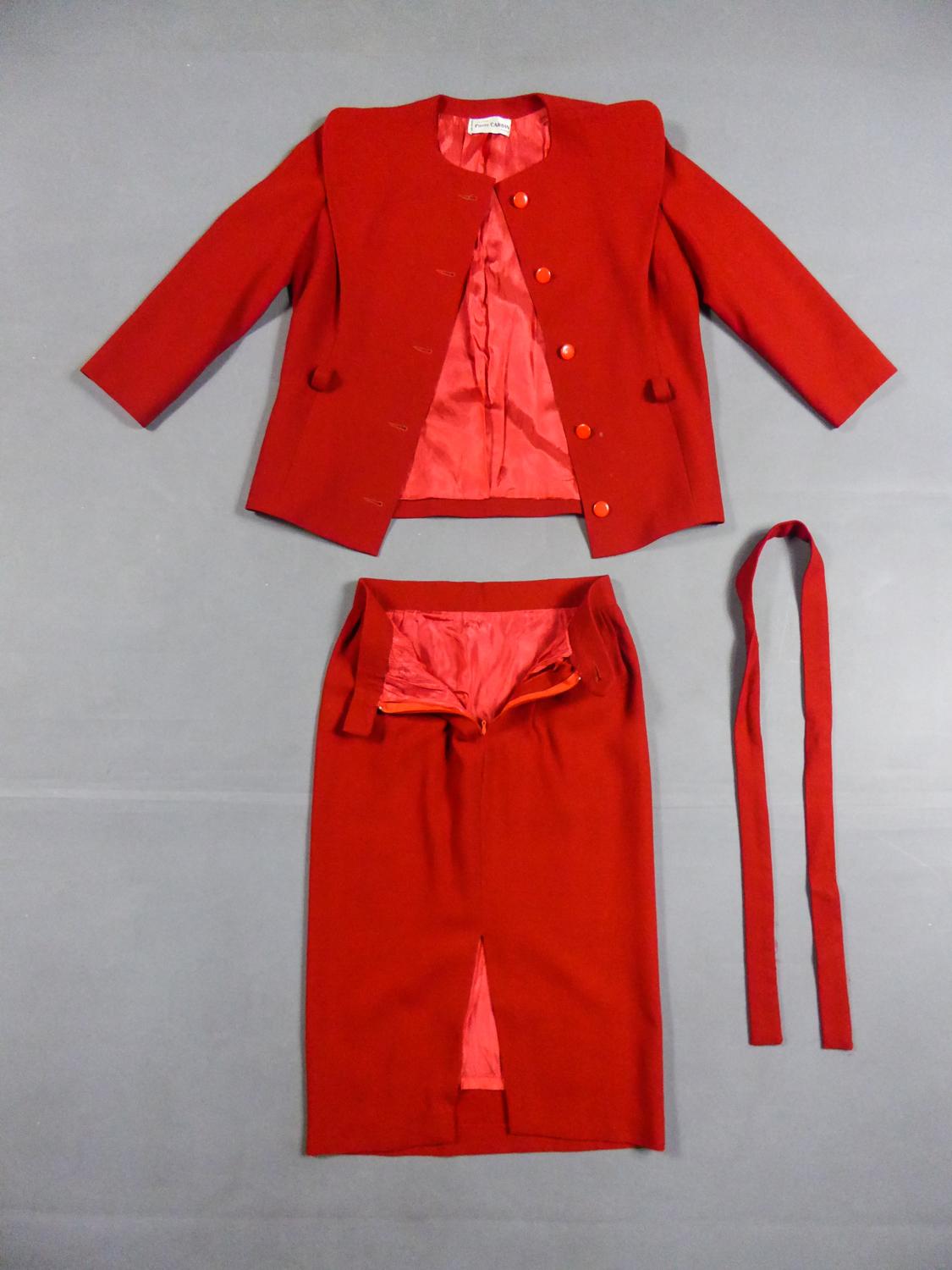 Circa 1980
France

Astonishing skirt suit in vermilion red wool, designed by Pierre Cardin from the 1980s. Jacket with long sleeves and plastron with integrated oversized false collar, marking a slender triangle shape marking the shoulders. Waist