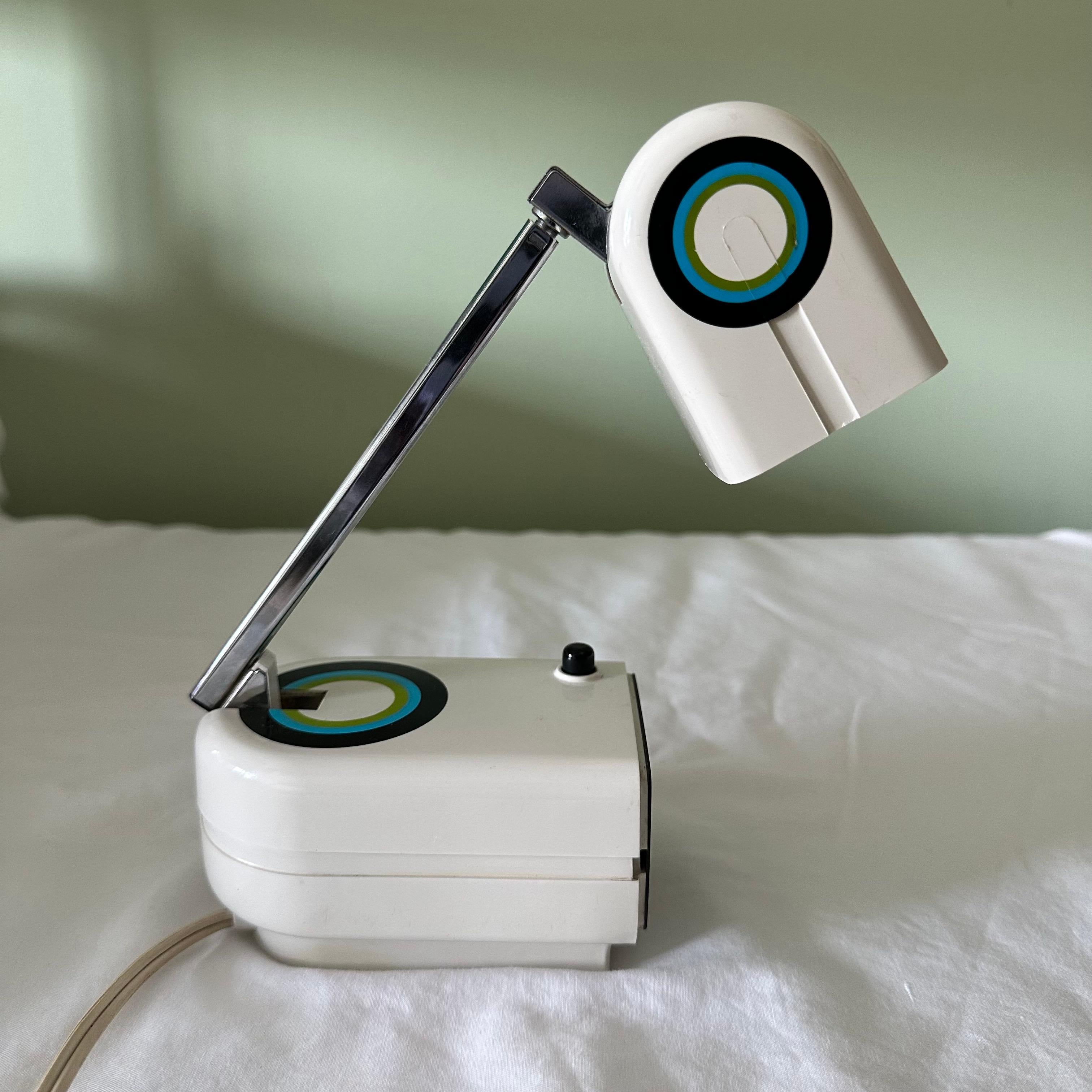 Rare Signed Pierre Cardin Space Age Telescopic Table Lamp in White, Blue, Green & Black. Can also be mounted on the wall as a wall lamp or sconce. Off-white in color, accented with a blue, green and black target bullseye design. Collapses into a