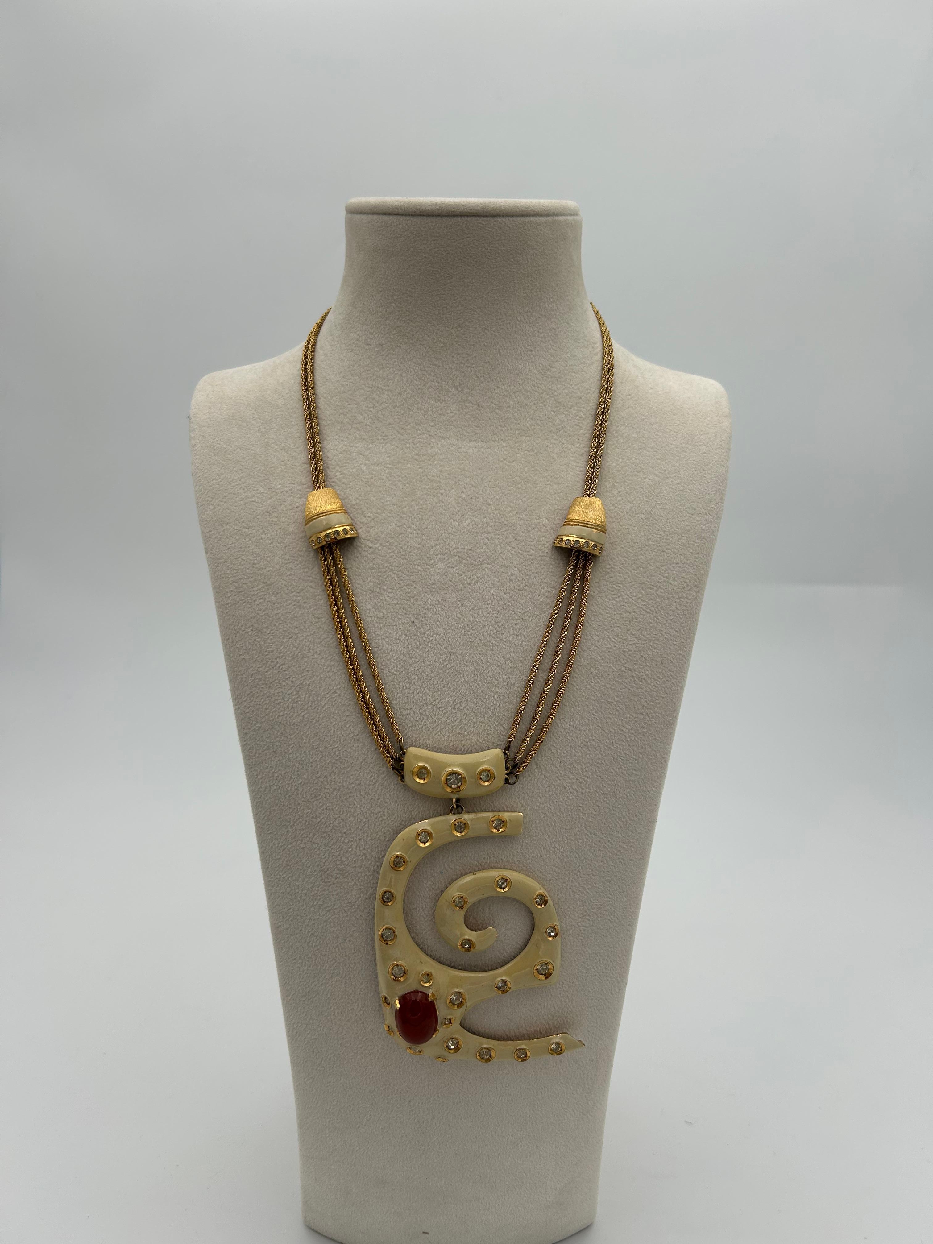 Pierre Cardin Statement Gold Toned Necklace. This statement piece is a perfect representation of the brands originality and creativity. This item elevate any outfit and is a perfect addition to your wardrobe. The multi-layer necklace adds dimension