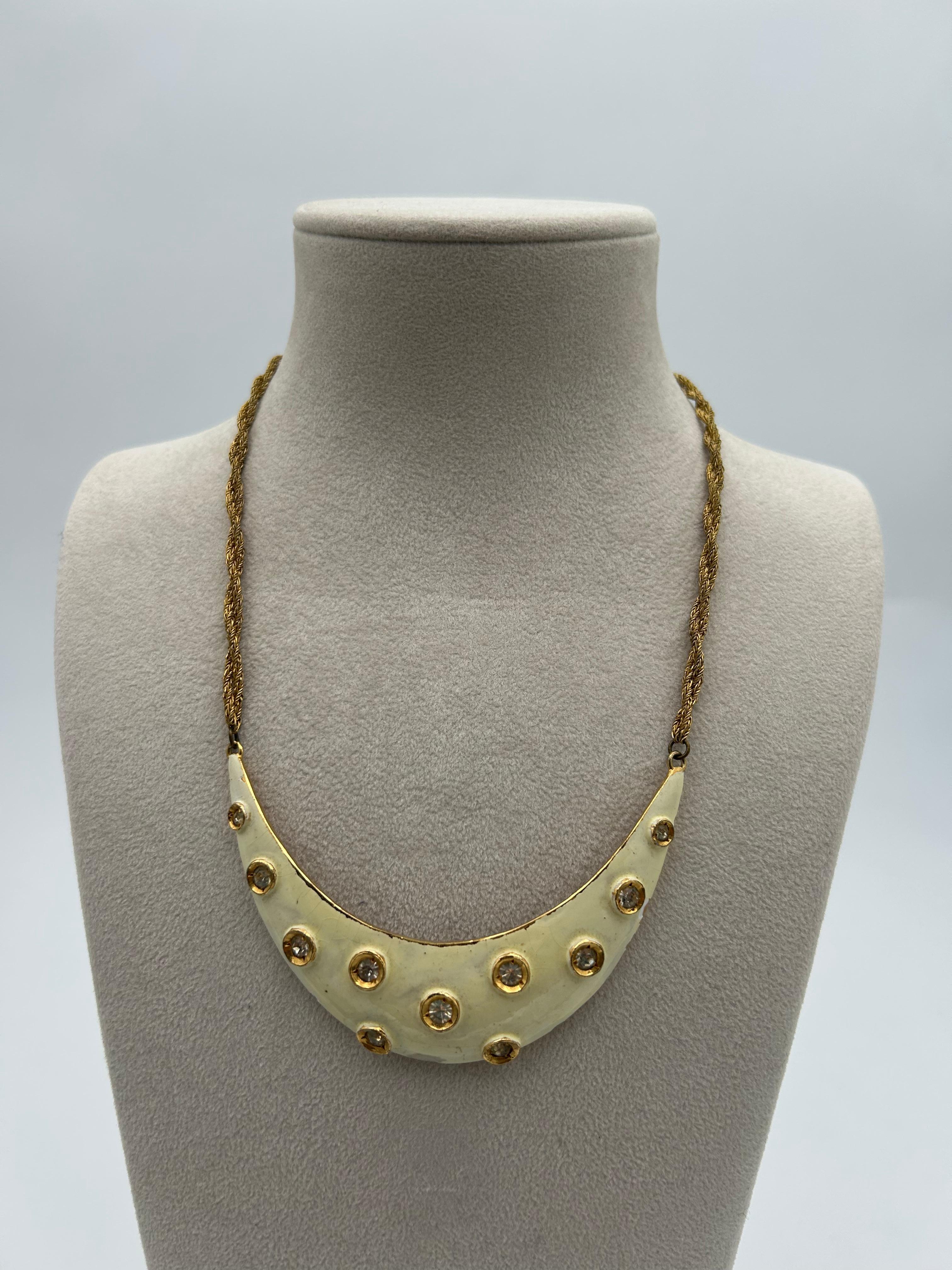 Pierre Cardin Statement Moon Necklace. This statement piece necklace is a beautiful item to add to your collection. The twisted multiple layered is a perfect addition to this necklace. 

In fair condition. 
Length = 19in. 
Pendant = 4in x 1in. 