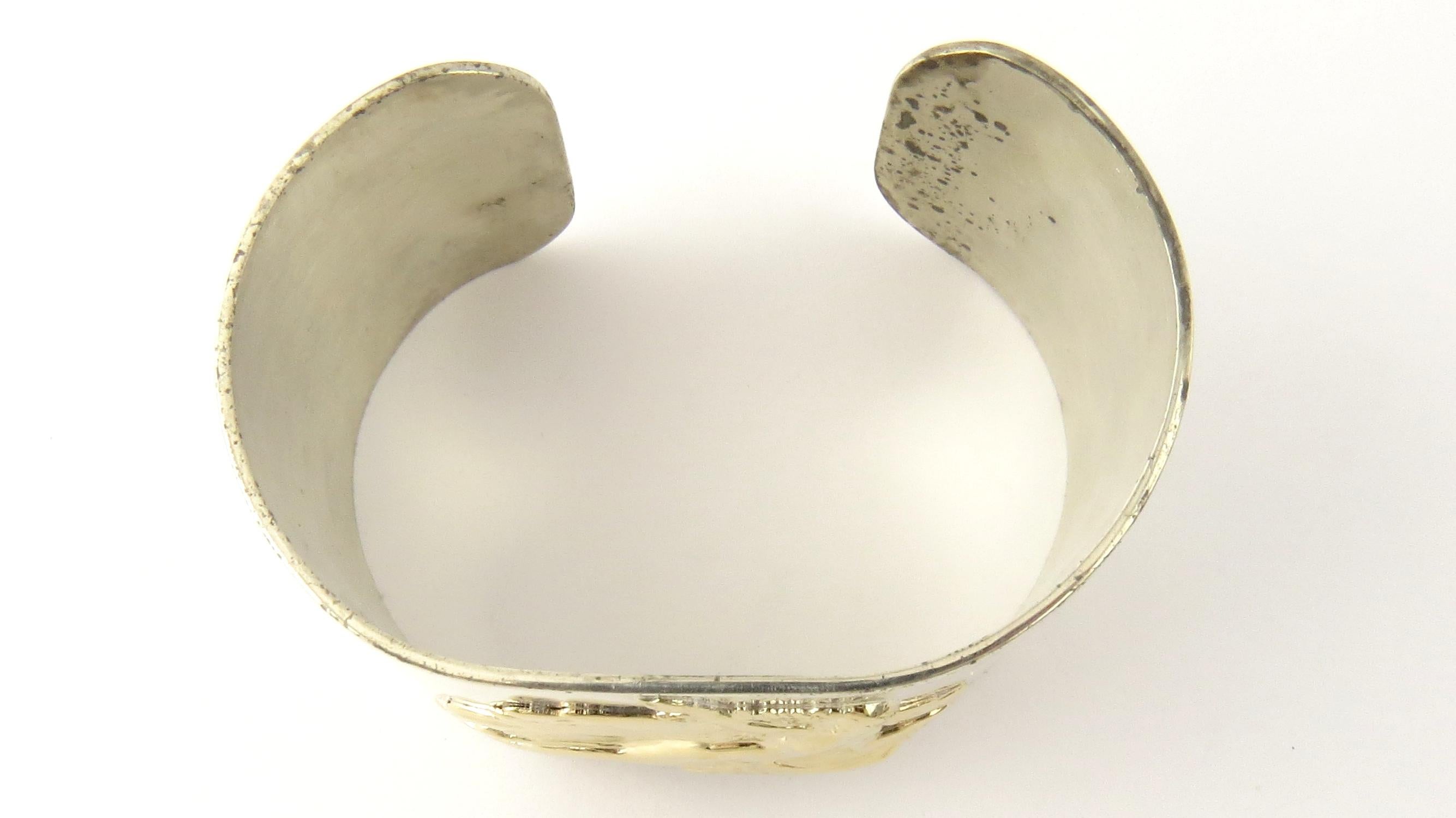 Vintage Pierre Cardin Sterling Silver and 14K Yellow Gold Aphrodite Mermaid Cuff Bracelet

This lovely sterling silver open cuff bracelet features Aphrodite, the goddess of love, crafted in classic 14K yellow gold. Width: 32 mm.

Size: 7