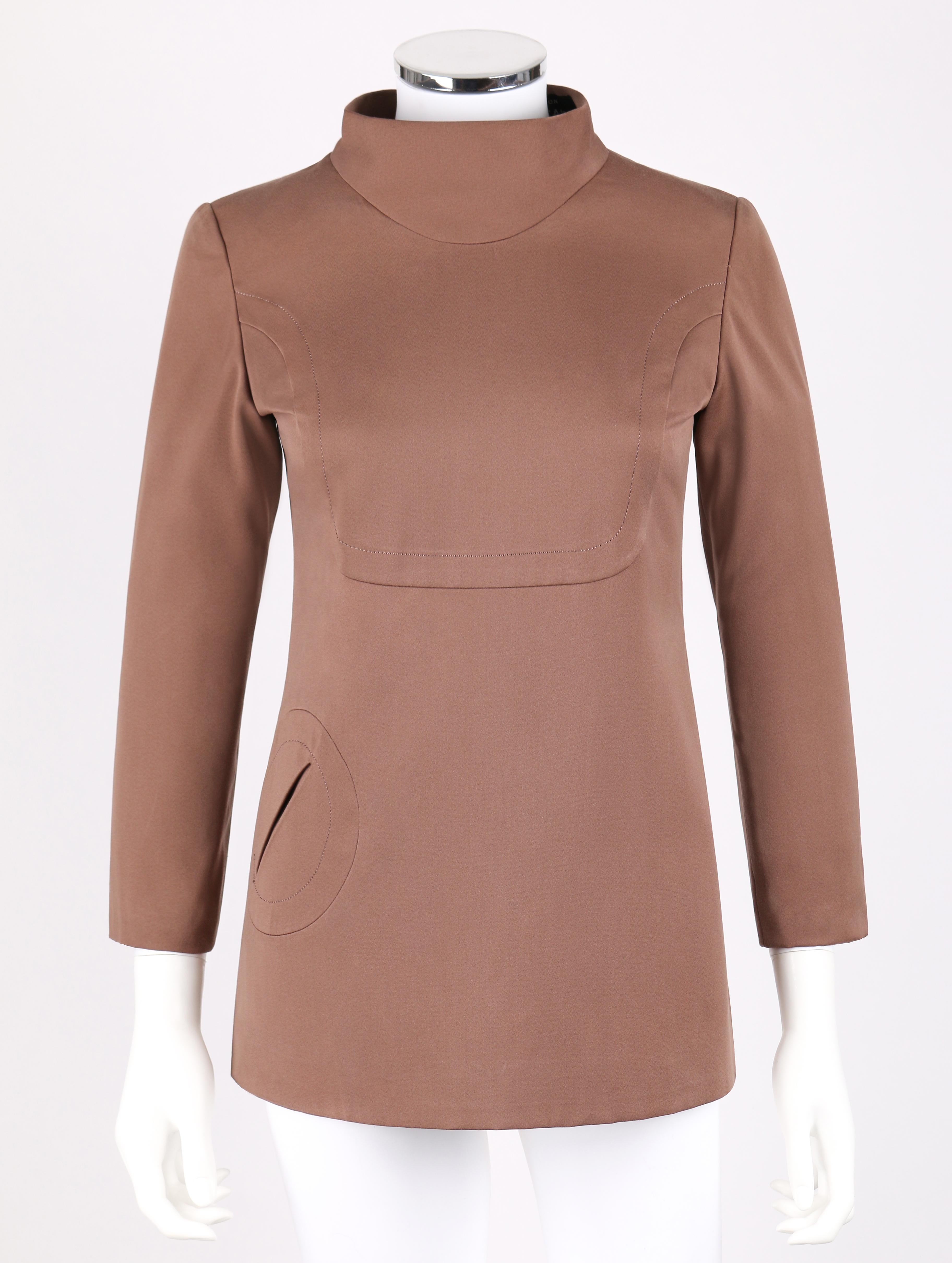 Vintage Pierre Cardin for Takashimaya c.1960's brown silk mod tunic. Top has signature circle shaped pocket at front. High standing collar. 3/4 length sleeves. Stylized u-shaped bust line. High slit at left side seam with rounded corners at hemline.