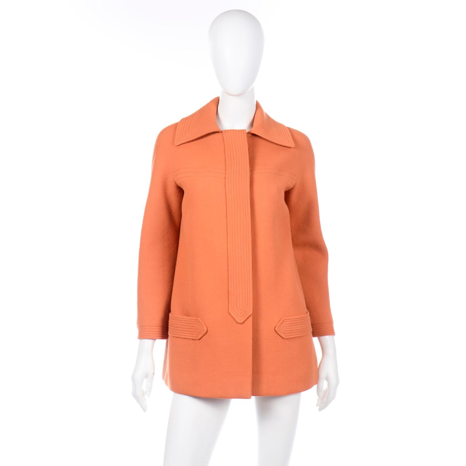 This vintage late 1960's or early 1970's Pierre Cardin orange wool jacket is such an iconic piece that will fit into any modern wardrobe!. This fabulous jacket has a pointed collar, placket covered buttons and two deep pockets at the hips. You will