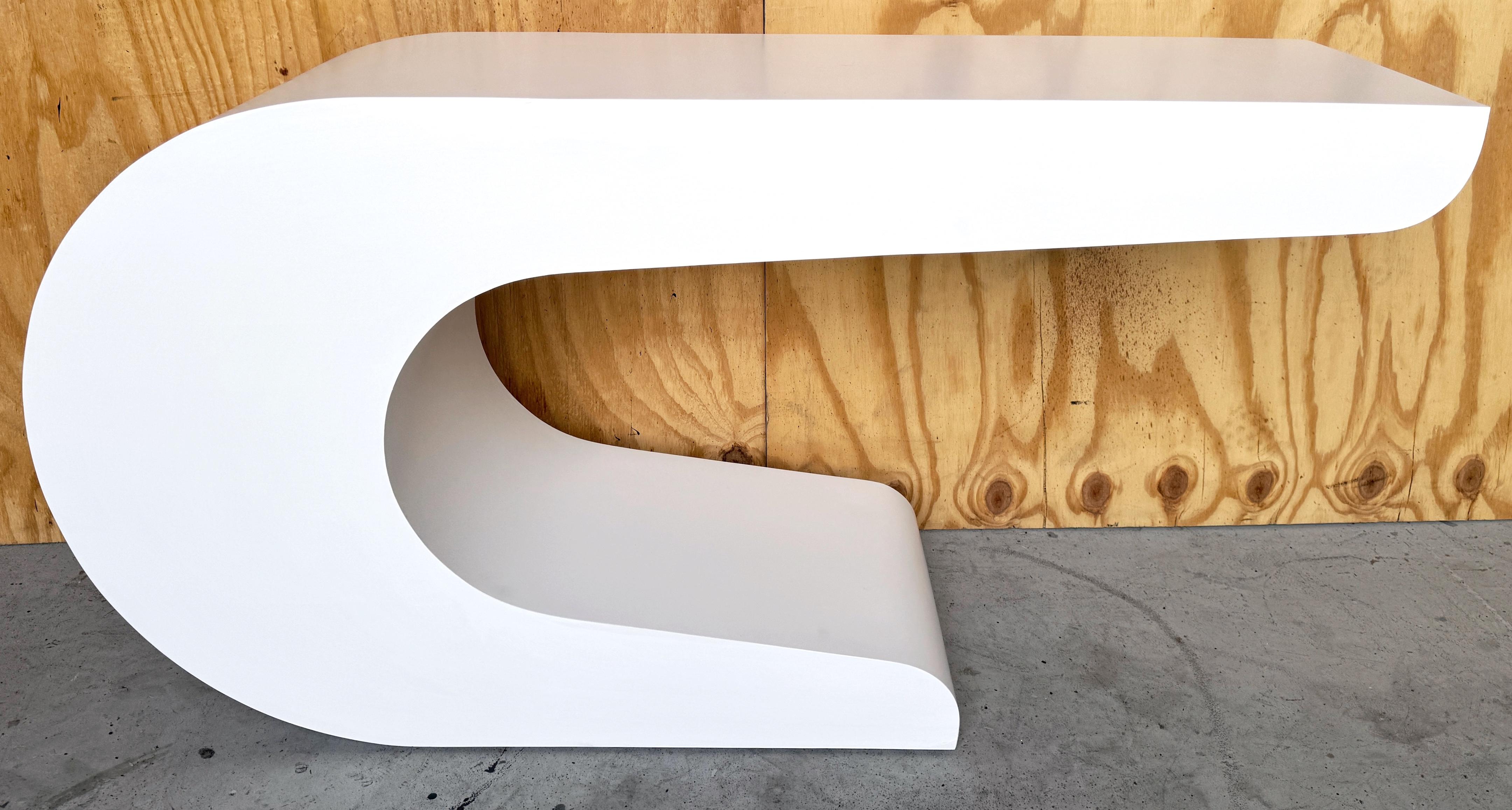 Pierre Cardin White Laquer Waterfall Console Table 
France, circa 1970s

Experience the epitome of 1970s chic with this Pierre Cardin White Lacquer Waterfall Console Table. Crafted in France circa 1970, this iconic piece showcases Cardin's
