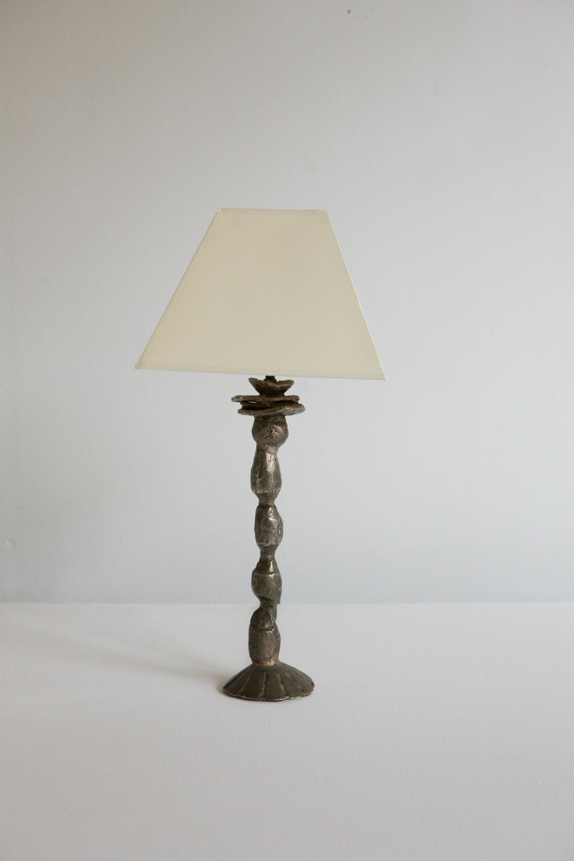 A very beautiful sculptural table lamp with a bronze base by the artists and designer Pierre Casenove for Fondica circa 1990's. The original scultpure would have been modelled out of clay and you can see the tool works in the resulting cast bronze.