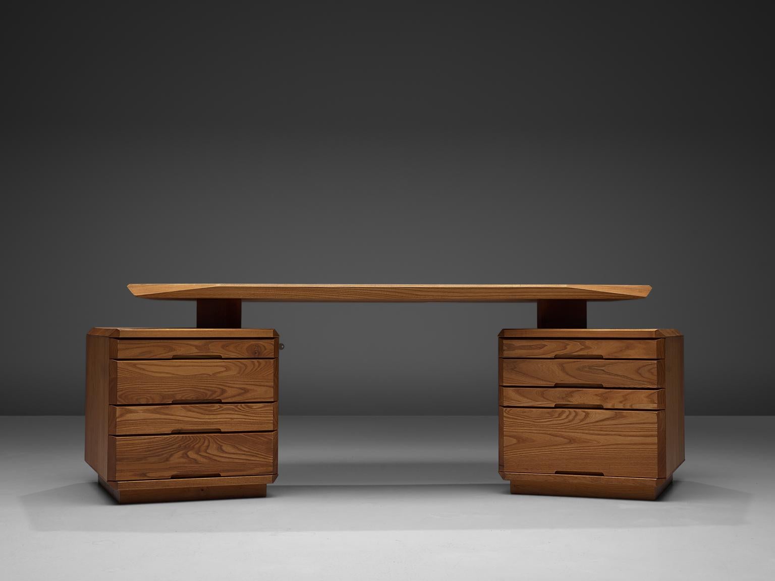 Pierre Chapo, B40 desk, elm, France, 1960s.

Characteristic desk by French designer and carpenter Pierre Chapo. Eye-catching detail is the beautiful carved tabletop, with slanted sides and corners. The tabletop rests on two cabinets that are