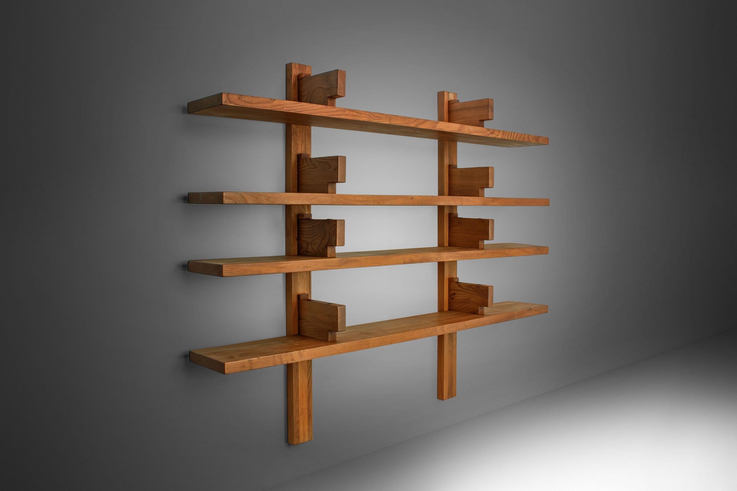 This elemental wooden bookshelf, ‘The Bibliothèque’ model no. B17, is one of the most quintessential pieces designed by Pierre Chapo.

It consists of four solid elm shelves that rest under brackets. Interestingly you would expect the shelves to rest