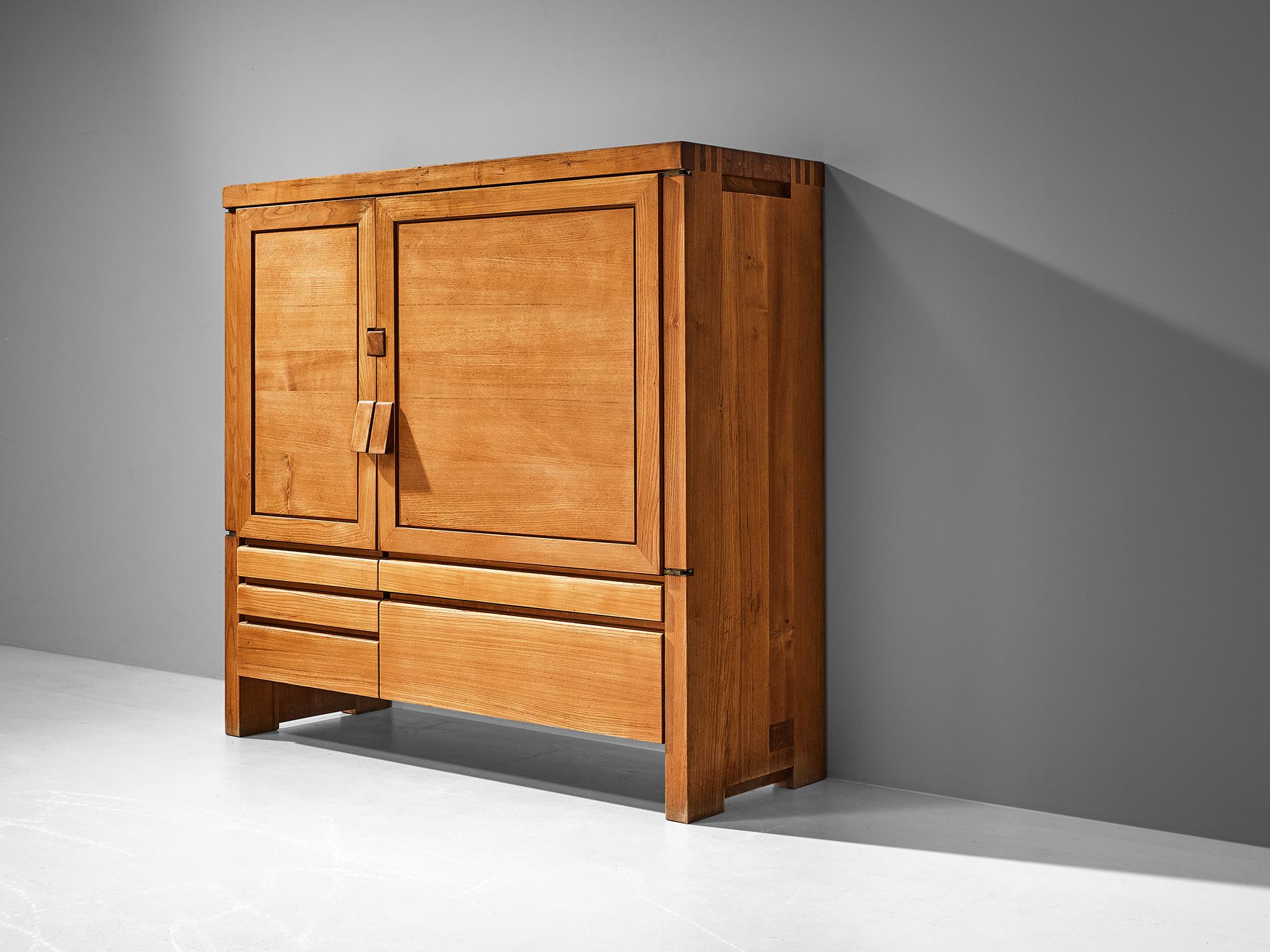 Pierre Chapo, cabinet model 'R18', solid elm, France, late 1960s.

This exquisitely crafted 'R18' cabinet combines a simplified yet complex design combined with nifty, solid construction details that characterize Chapo's work. Two doors of