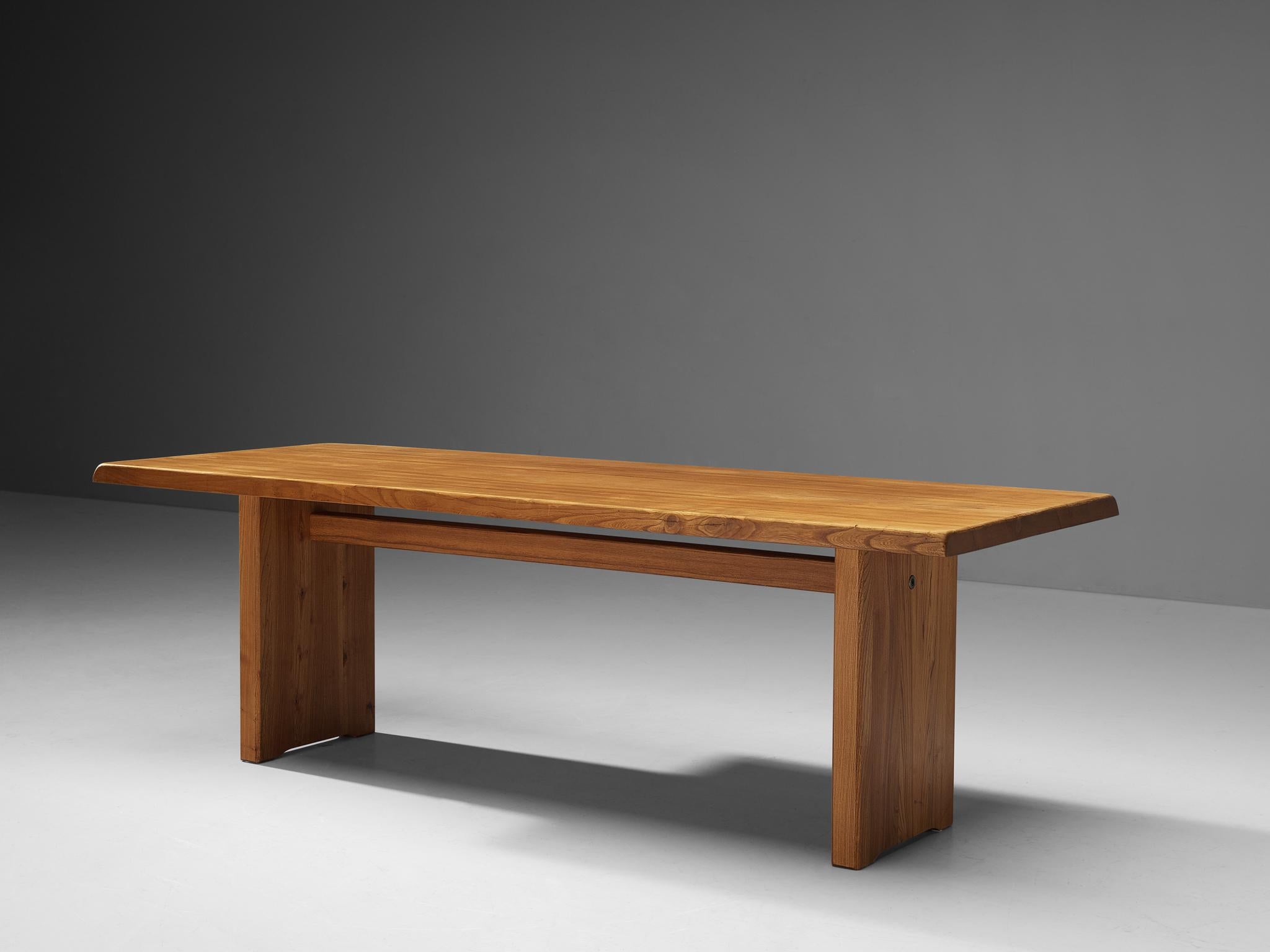 Pierre Chapo, dining table,  model 'T14D', elm, France, 1960s. Width: 224cm/7.4 ft

This table is an early edition, created according to the original craft methodology of Pierre Chapo. The rectangular tabletop with sloping edges rests on a