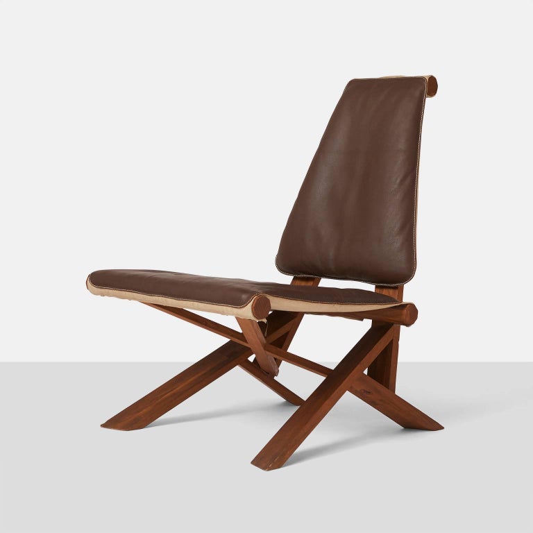 A rare Pierre Chapo model S46 lounge chair in elm wood with a brown leather seat and backrest. This chair is from Chapo's chlacc series. The seat can be folded upwards and depending on your weight and posture, the wood at the legs tilts upwards, so