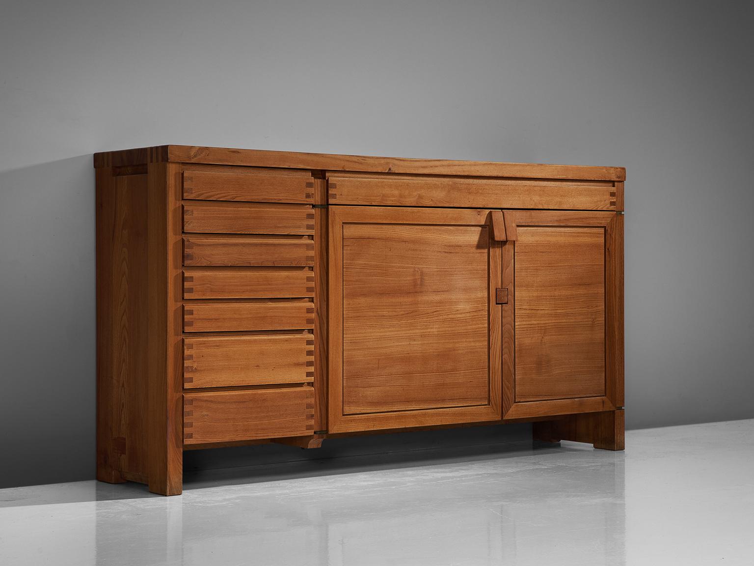 Pierre Chapo, sideboard, two-door and eight drawer sideboard model R13A, elm, France, 1964.

This exquisitely crafted credenza combines a simplified yet complex design combined with nifty, solid construction details that characterize Chapo's work.