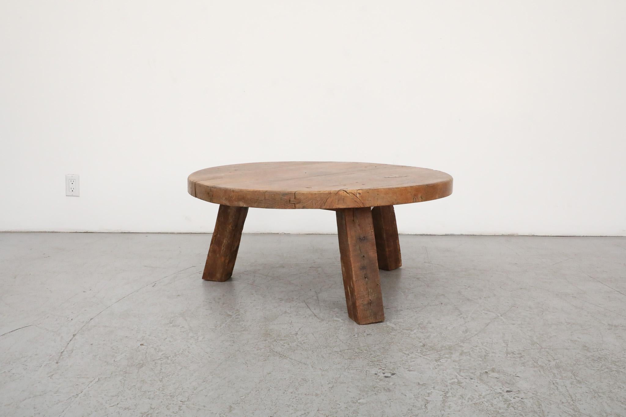 This 1960's Pierre Chapo Inspired heavy Brutalist coffee table is made from solid oak, with a hand waxed finish, round top and fat tripod legs. In original condition with visible wear, including some natural cracking. Wear is consistent with its age
