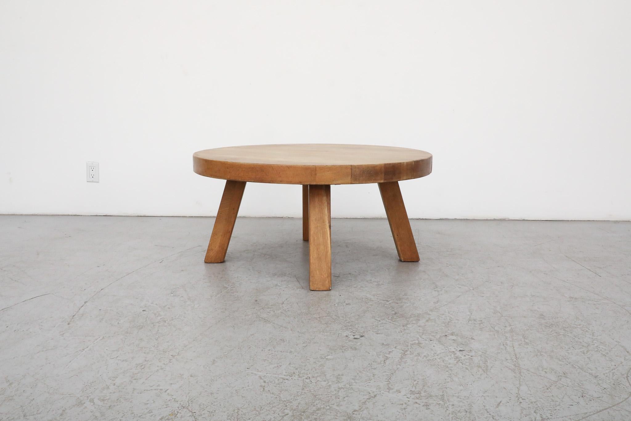 This Mid-Century, Brutalist beauty is solid and HEAVY and all original. It has a thick round solid oak slab top with four sturdy square slightly splayed legs. Designed in the style of French Mid-Century great Pierre Chapo. In original condition with