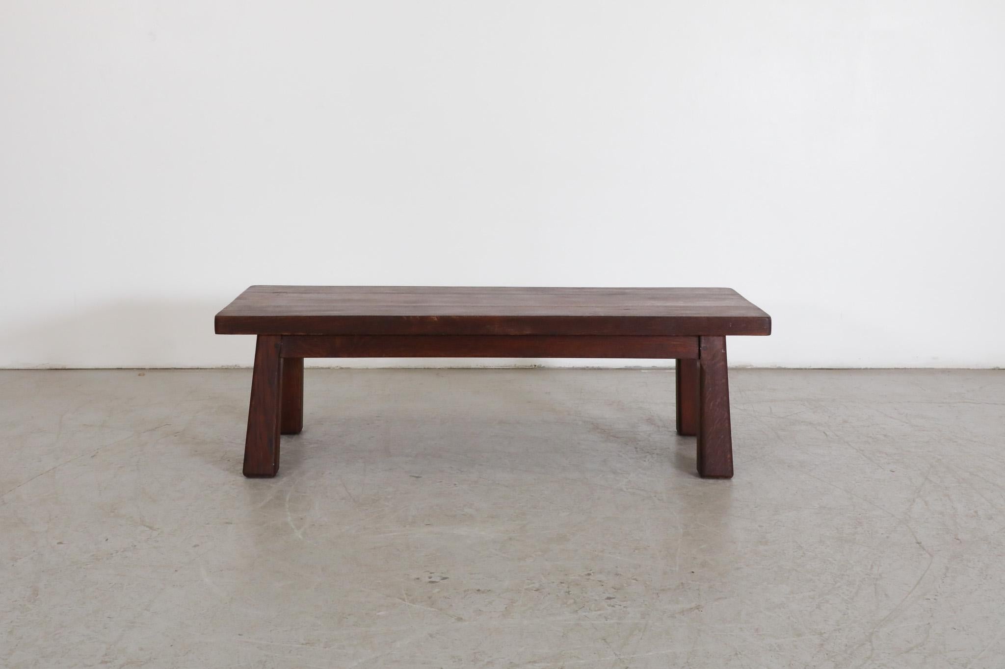 Brutalist, Pierre Chapo inspired, Mid Century coffee table or bench made from solid, dark stained oak. In original condition with visible wear, including some natural cracking. Wear is consistent with its age and use. Another similar lighter table