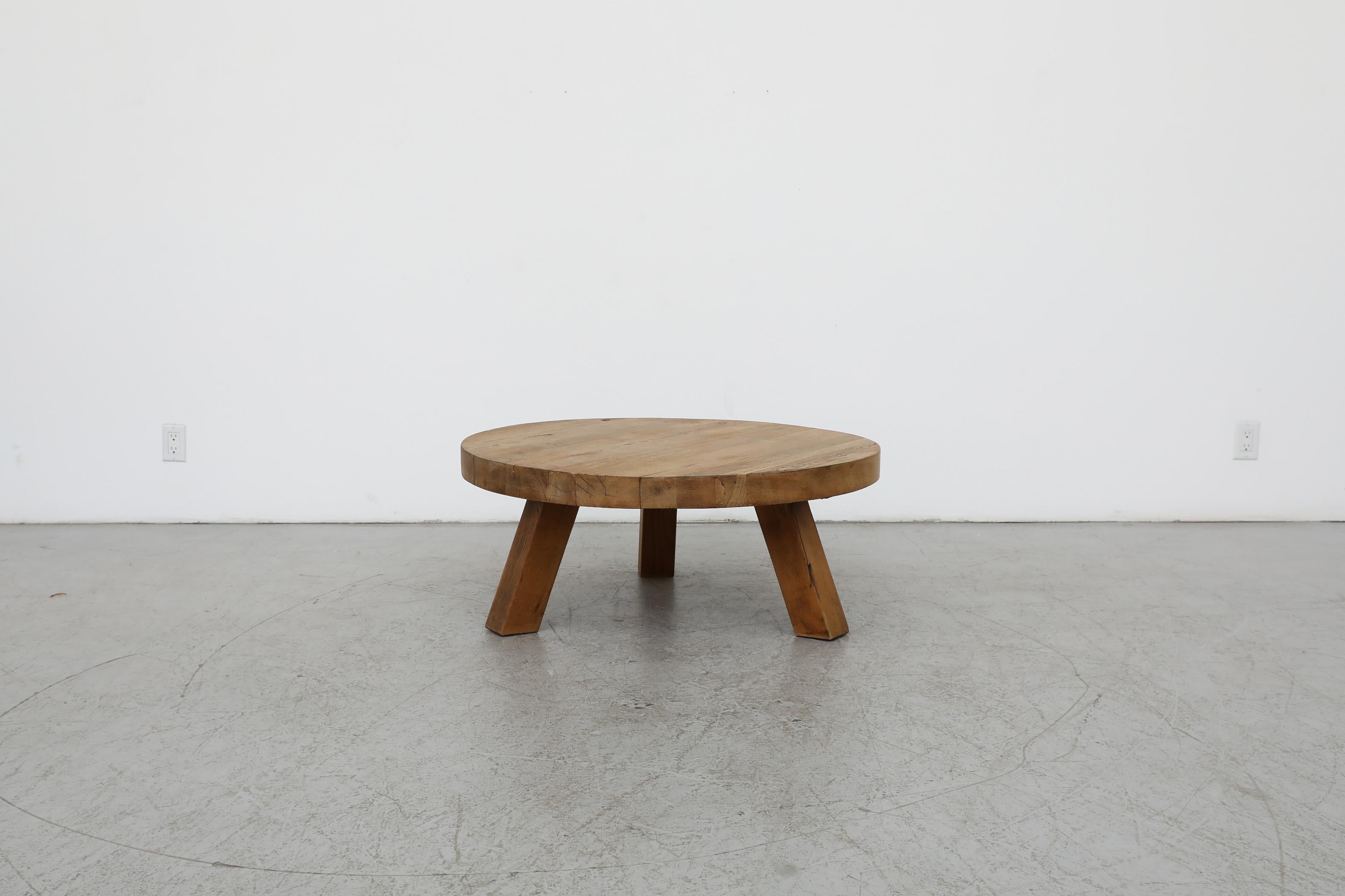 Belgian, Brutalist, heavy round coffee table from solid oak. Outfitted with three very sturdy square legs. In original condition with visible wear and patina consistent with its age and use. Other similar tables available and listed separately. 