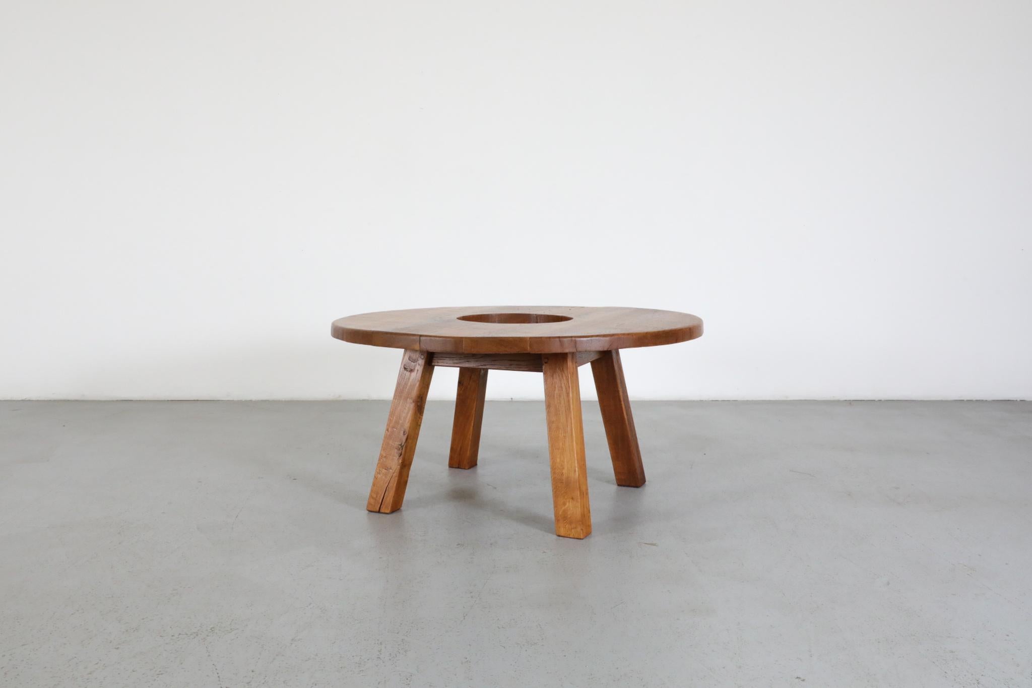 Brutalist Pierre Chapo inspired round coffee table with center cut-out detail in the center. Table is made out of solid oak. Cut out measures 12.625” x 12.625”. In original condition with visible wear consistent with its age and use.