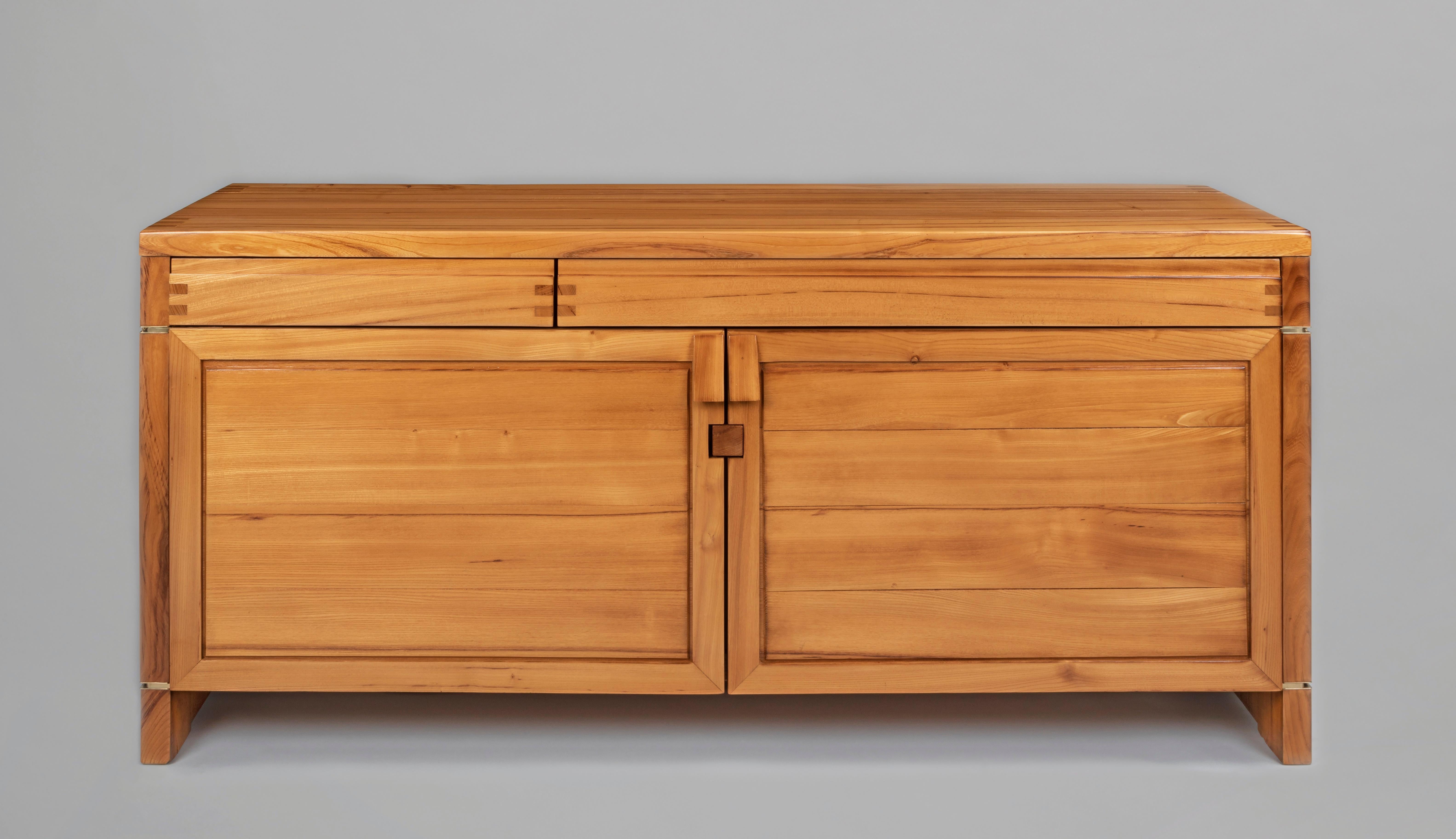 Pierre Chapo (1927–1987)

A superbly crafted, sparely designed, and imposingly scaled two-door sideboard by master artisan Pierre Chapo. In solid elm with brass hinges, asymmetrical frieze drawers, and beautiful exposed joinery, this cabinet is